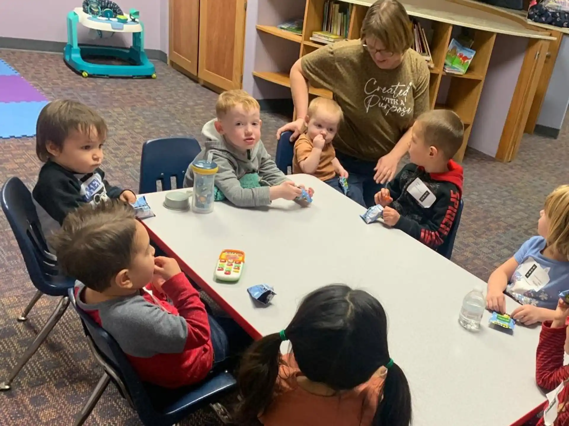 a group of children sitting around a table
