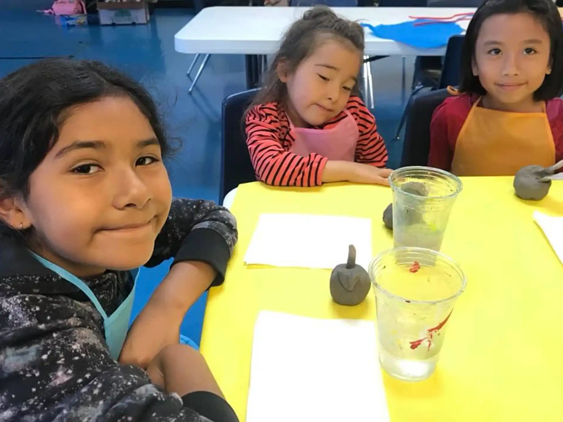 a person and two children sitting at a table