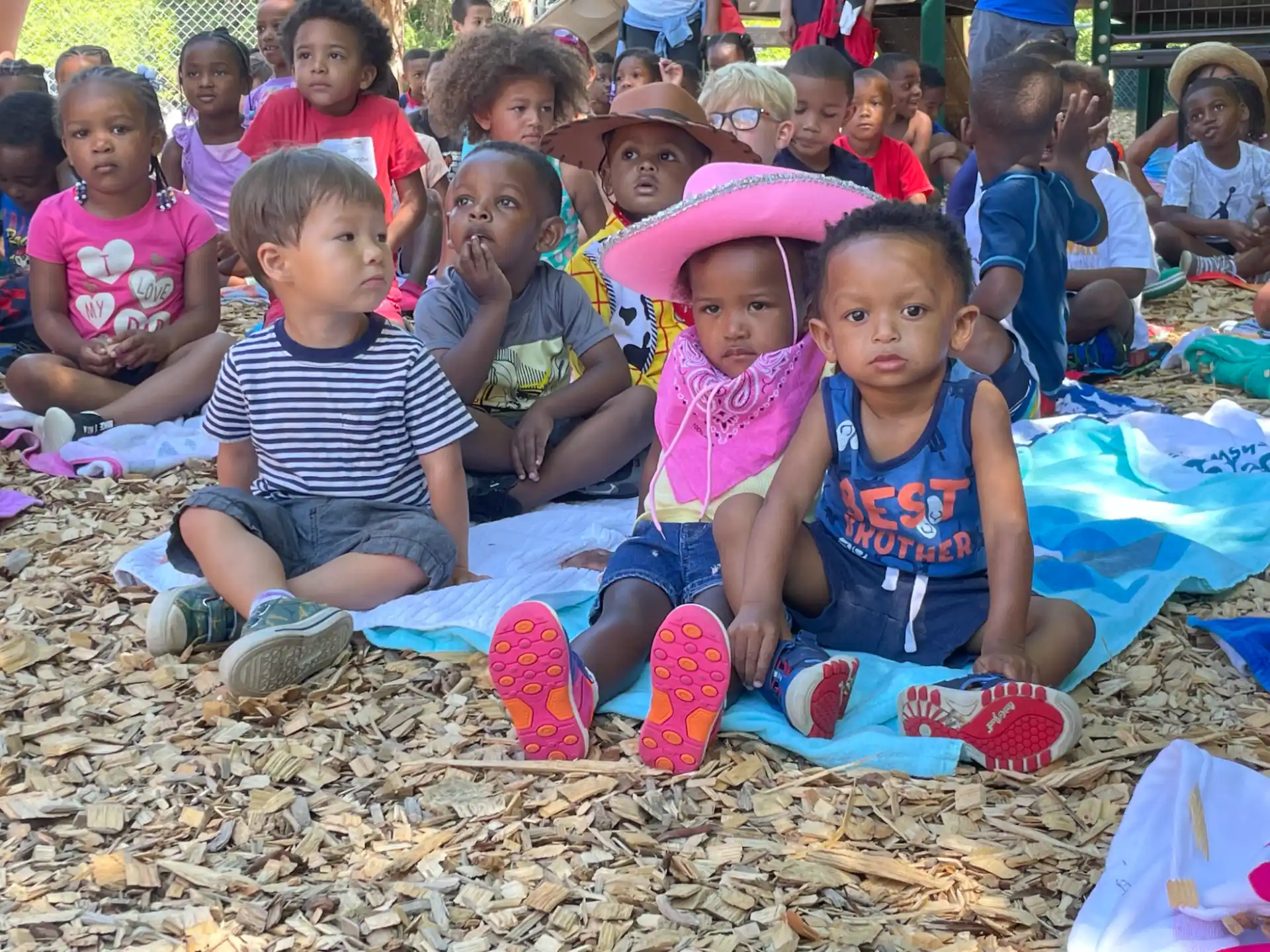 a group of children sitting on the ground