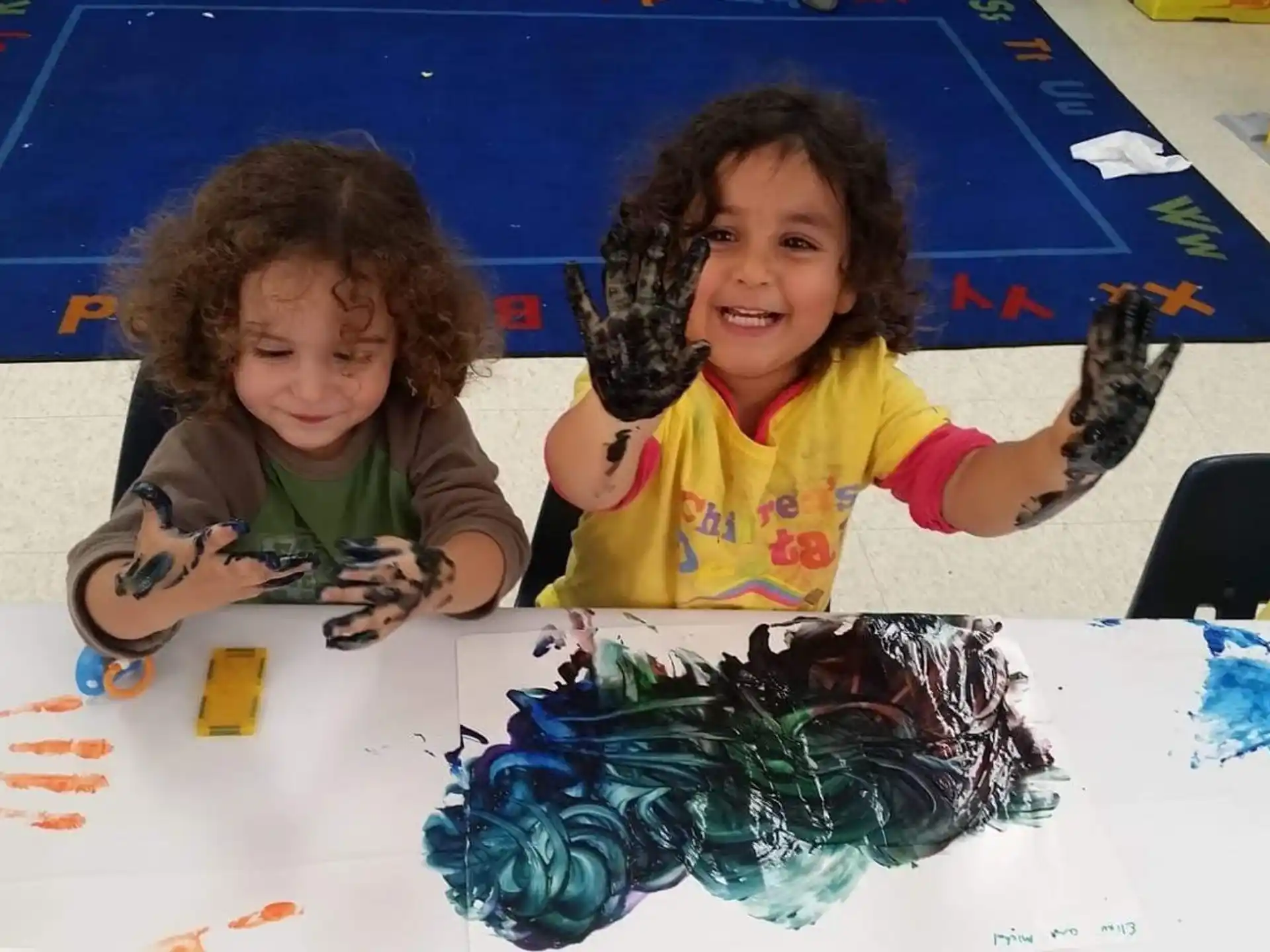 a couple of young girls painting