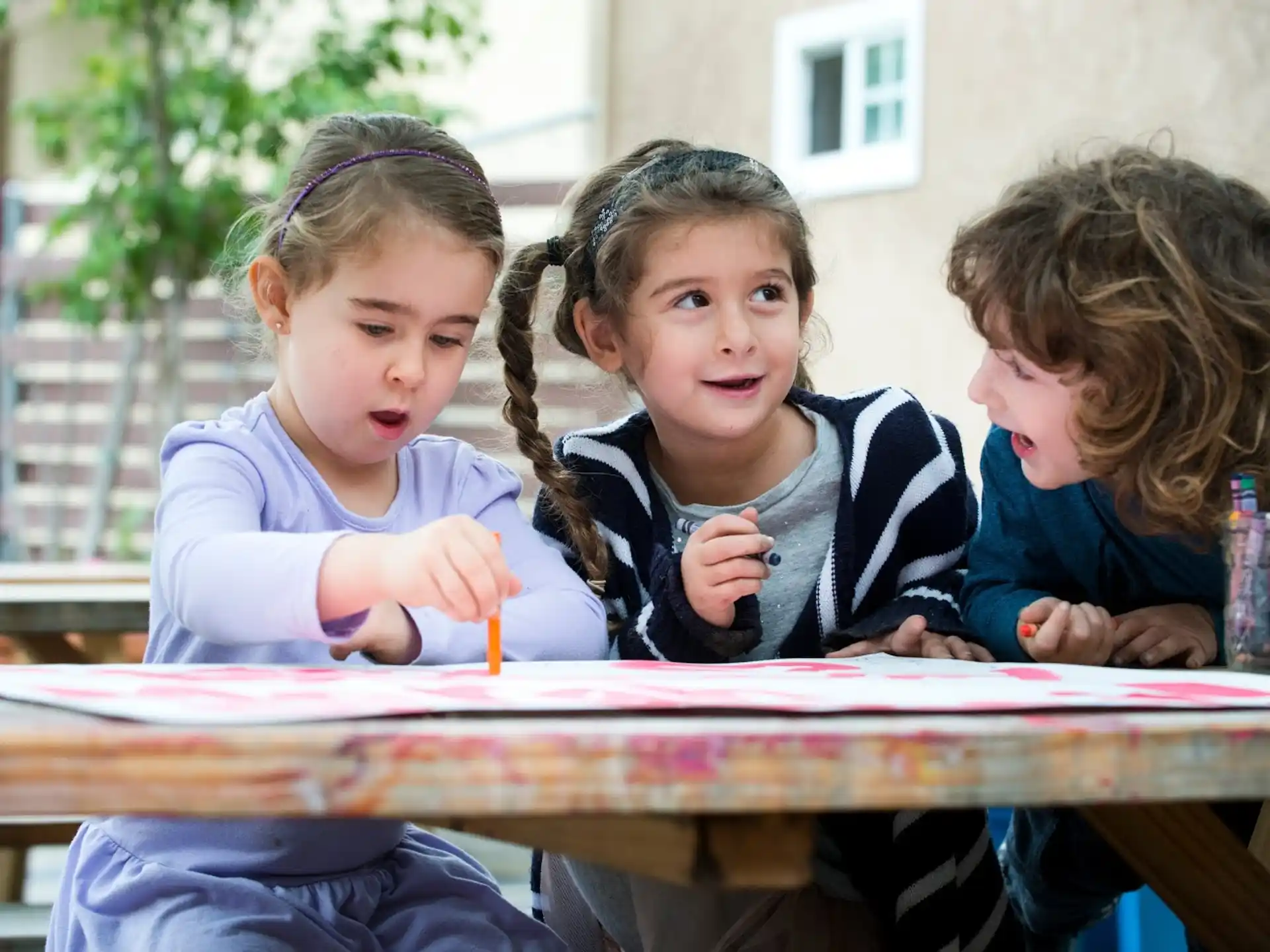 a group of children sitting at a table
