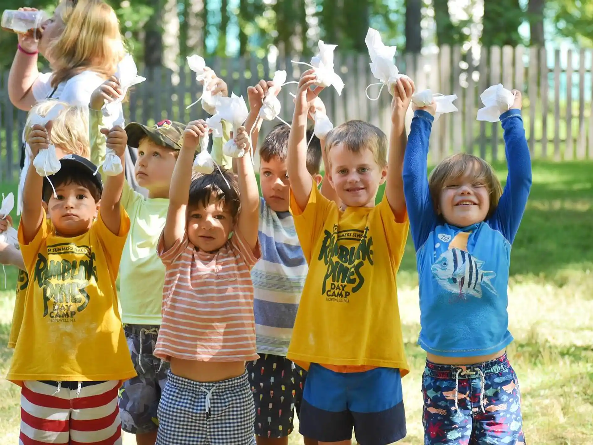 a group of children holding up a white rabbit