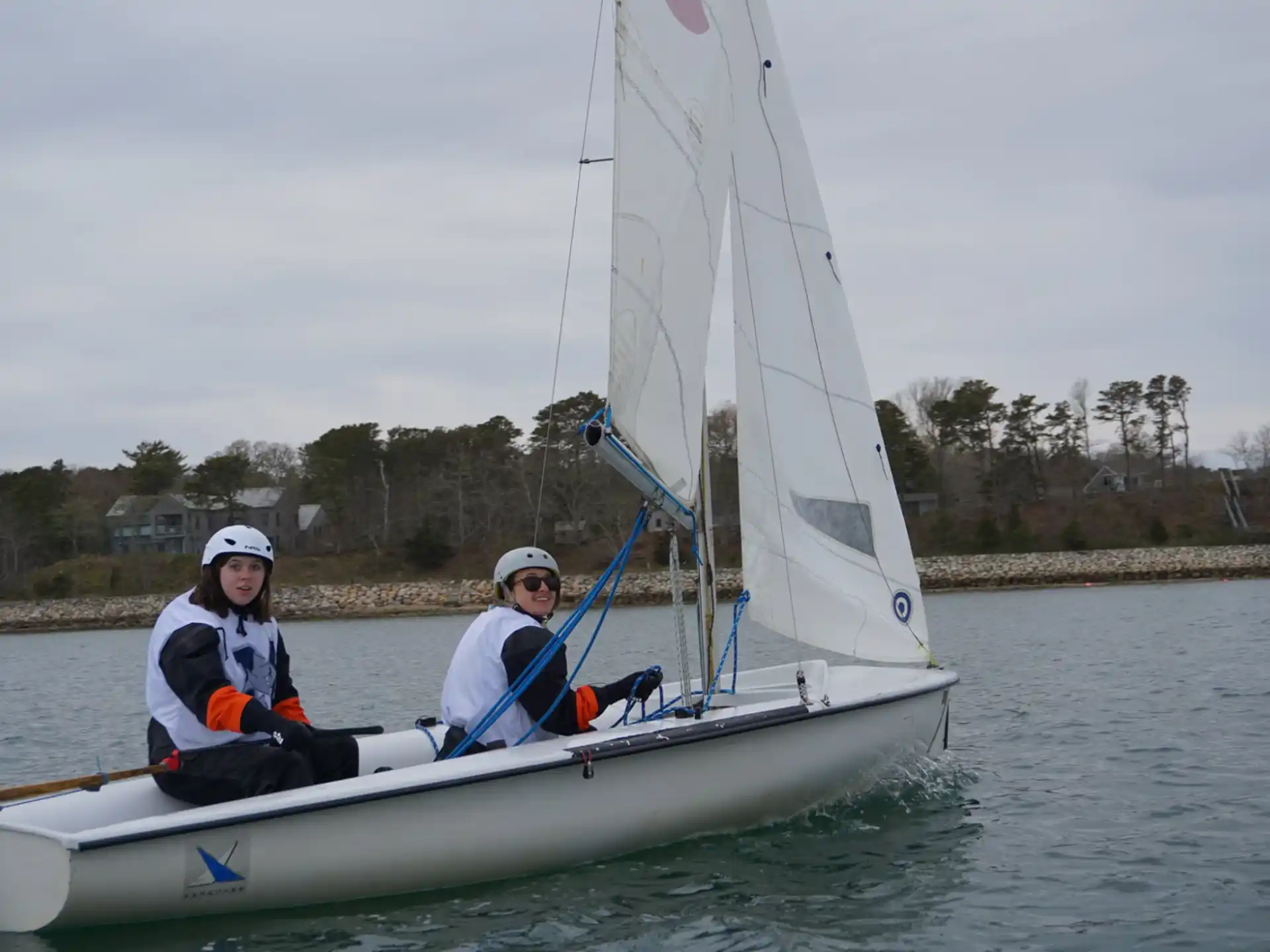 a group of people on a sailboat on water