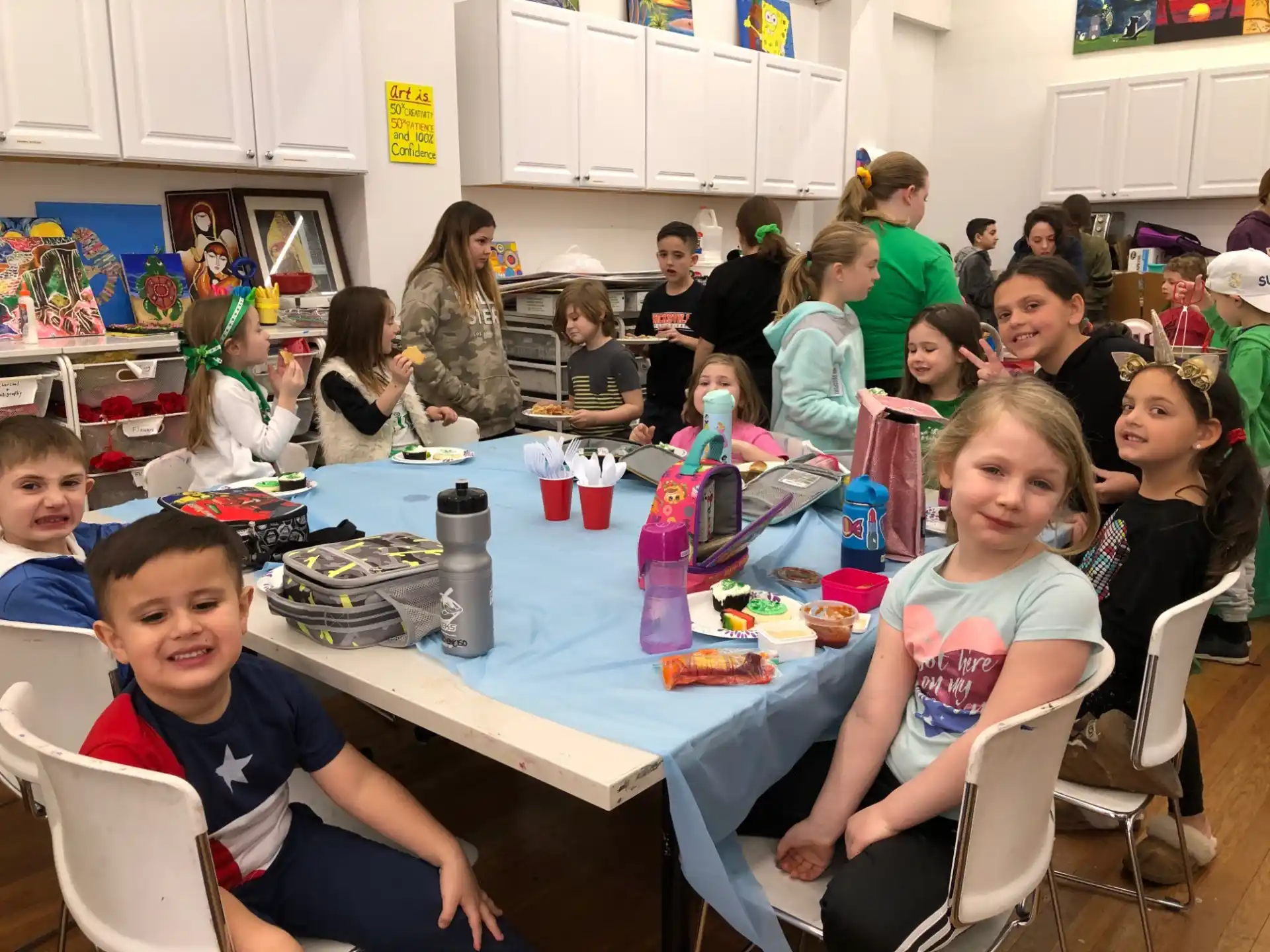 a group of children sitting around a table