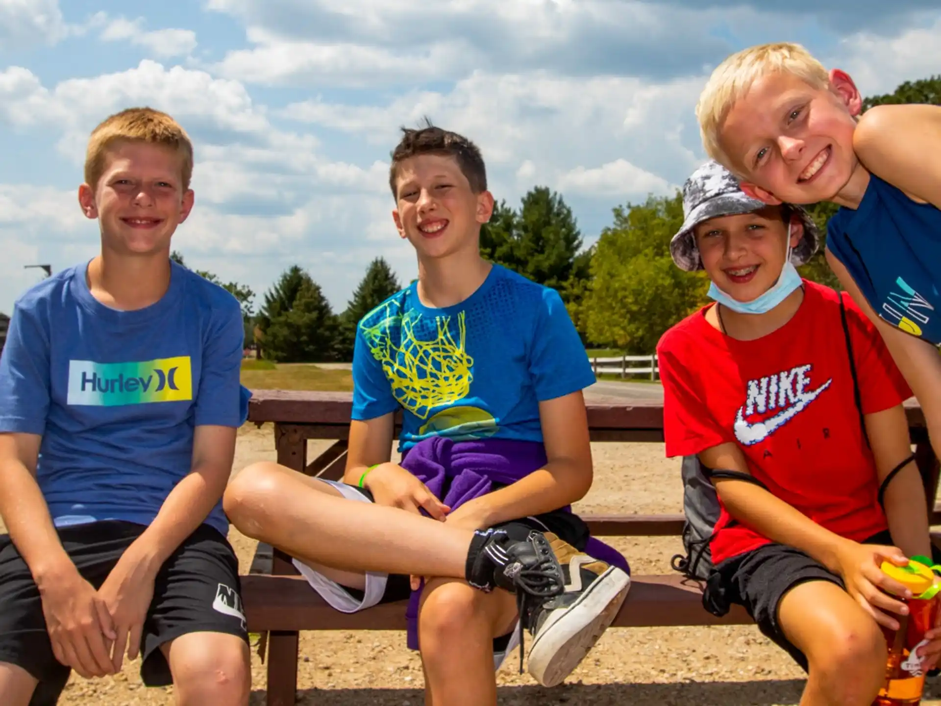a group of boys sitting on a bench