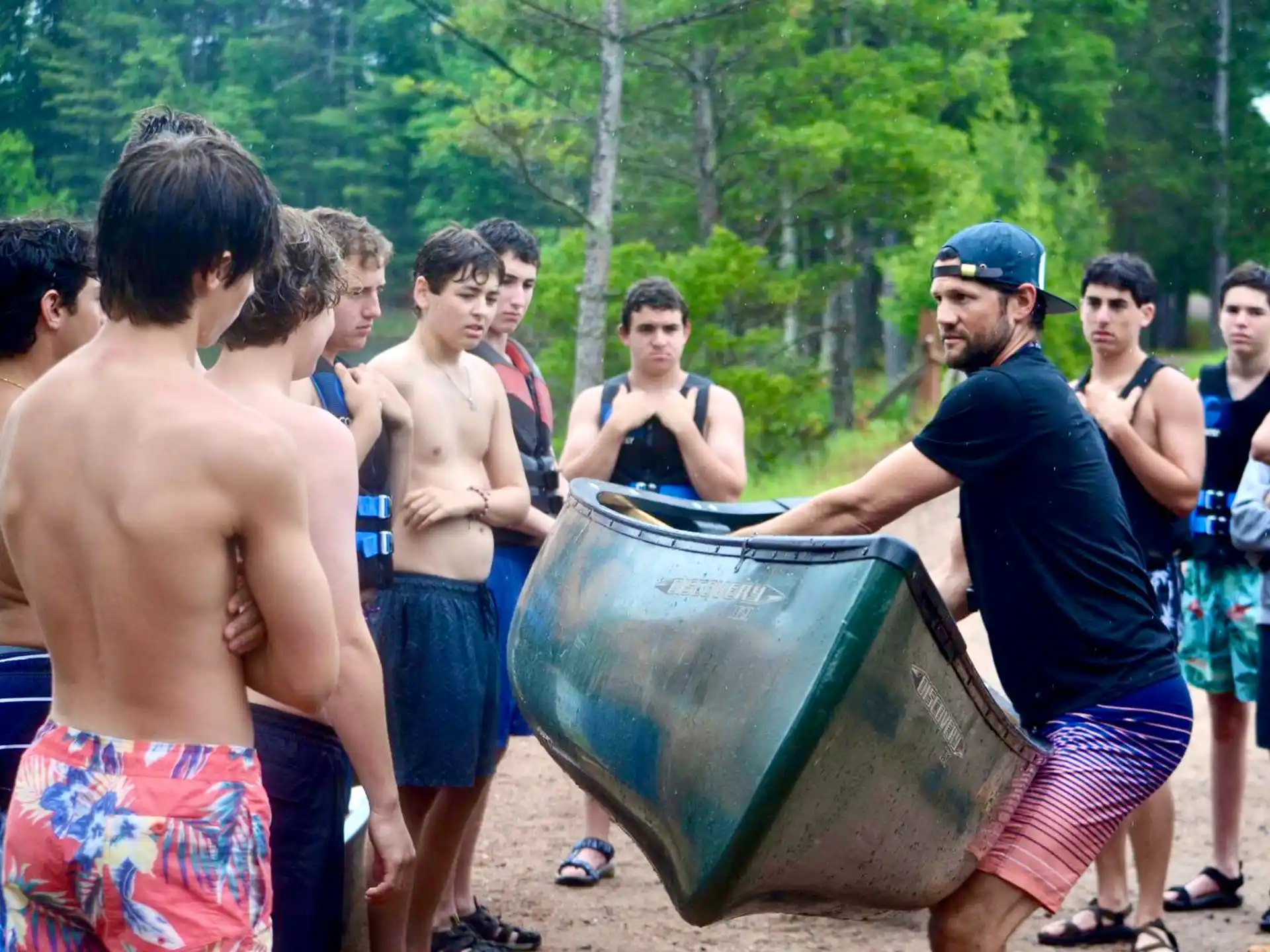 a group of men standing around a large barrel