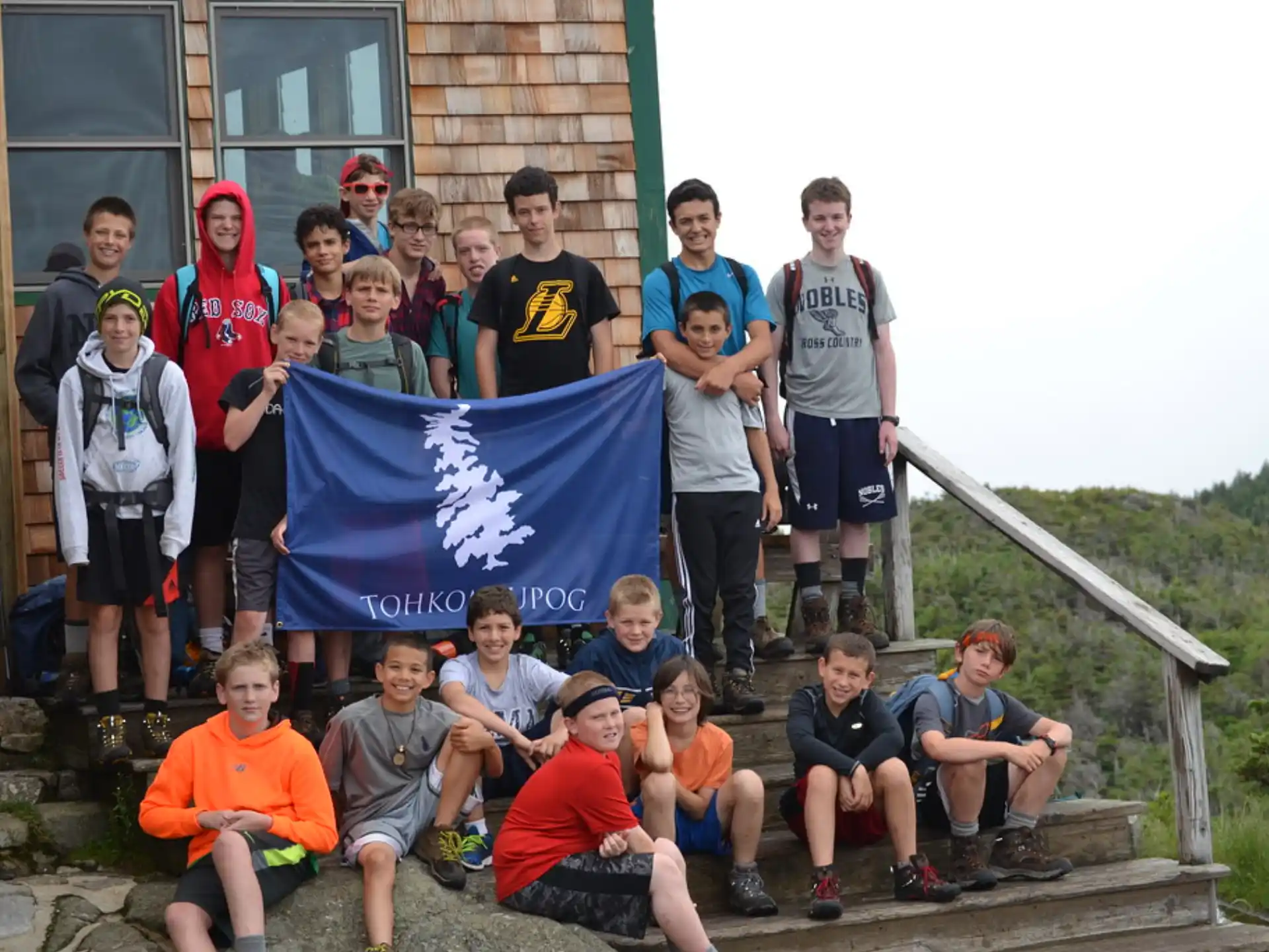 a group of people posing for a photo with a flag