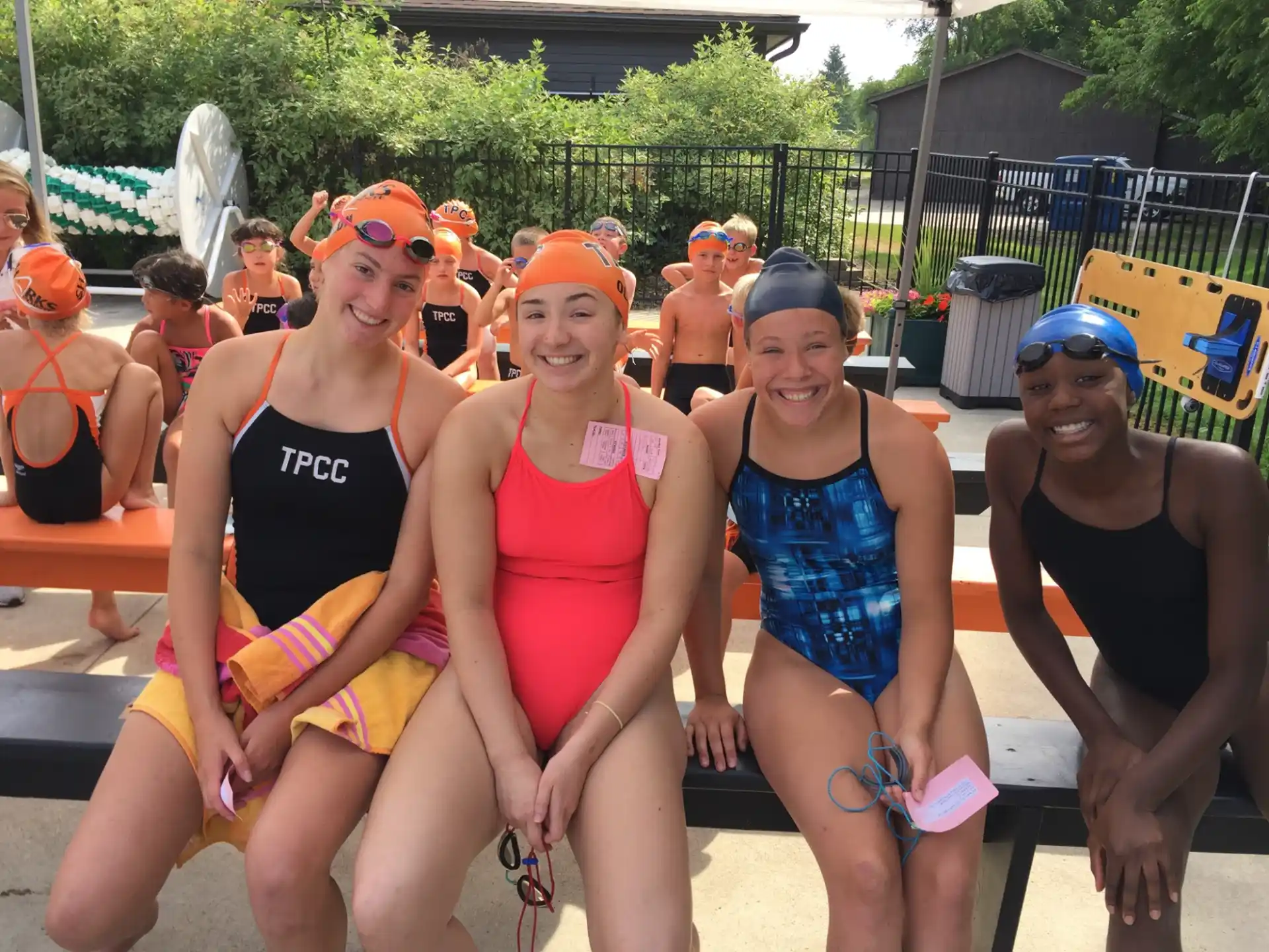 a group of people in swimsuits posing for a photo