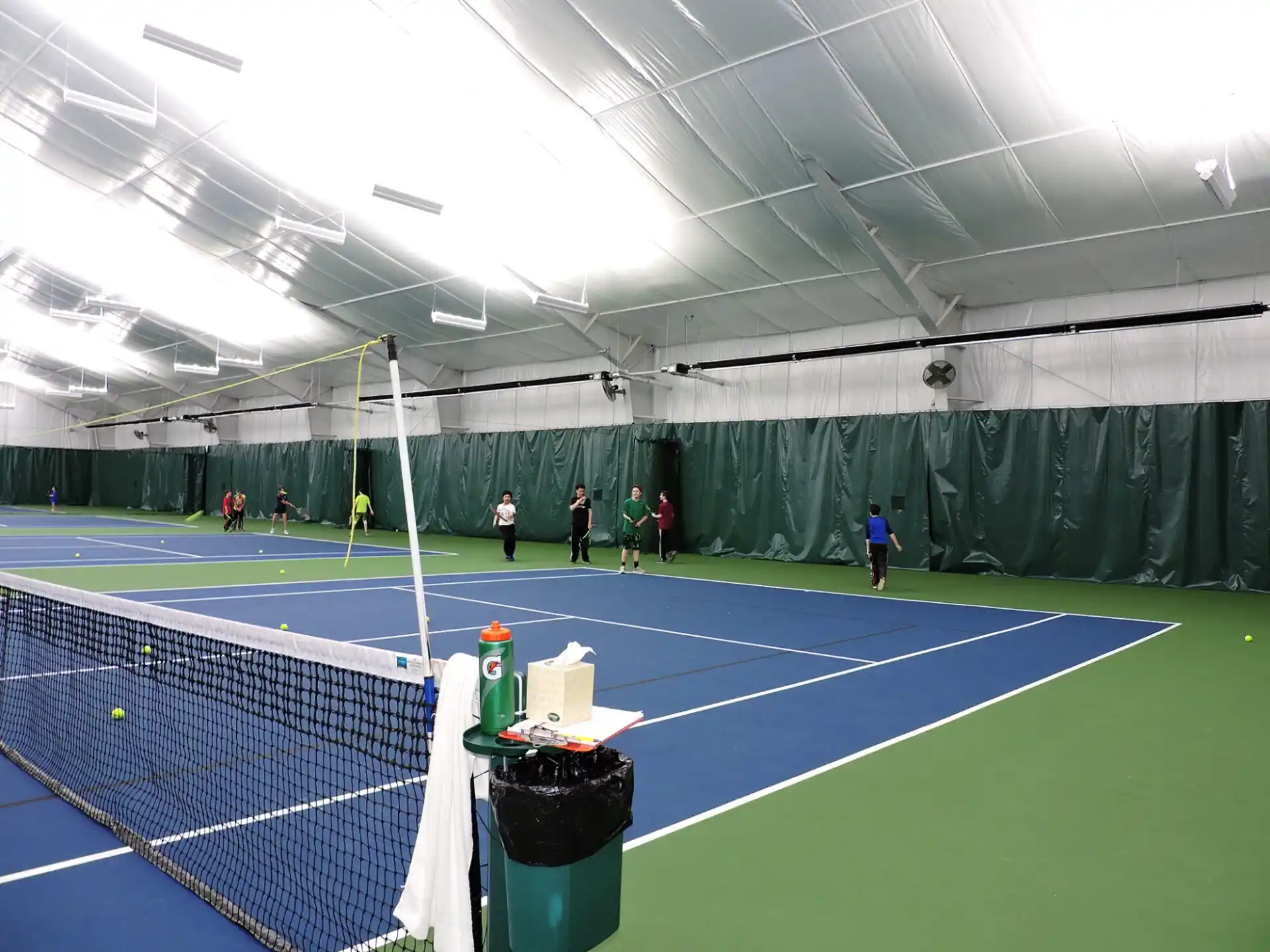 a group of people on a tennis court