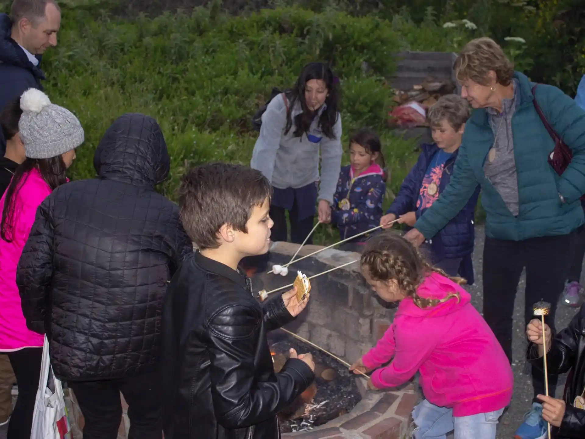 a group of people around a grill