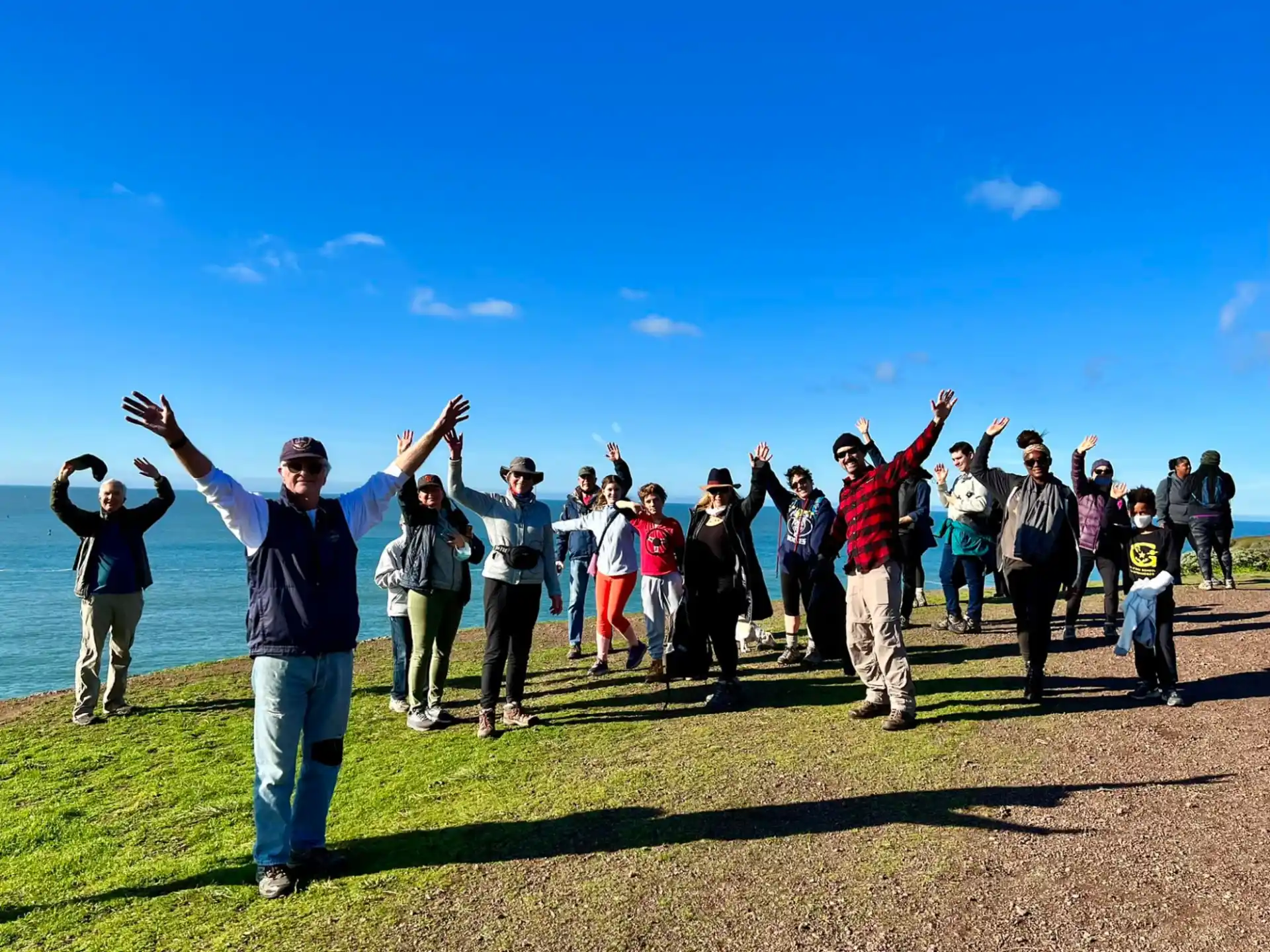 a group of people standing on a field with their arms raised