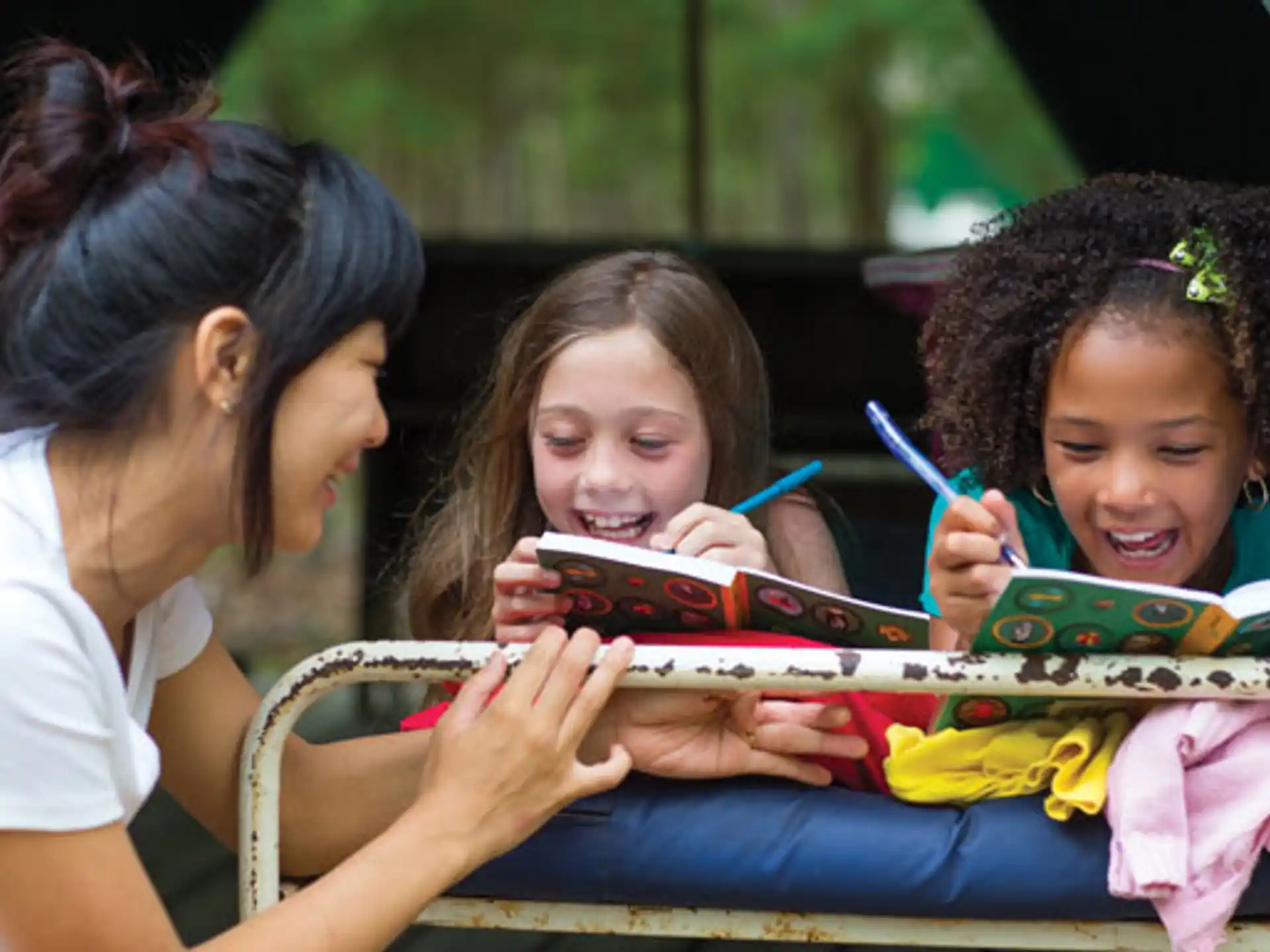 a group of children looking at a book