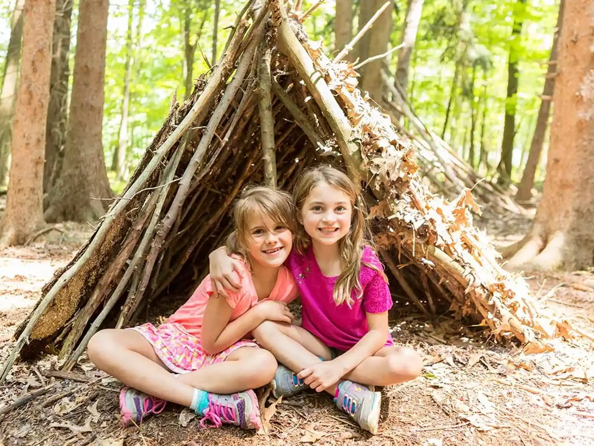 two girls sitting in a tree