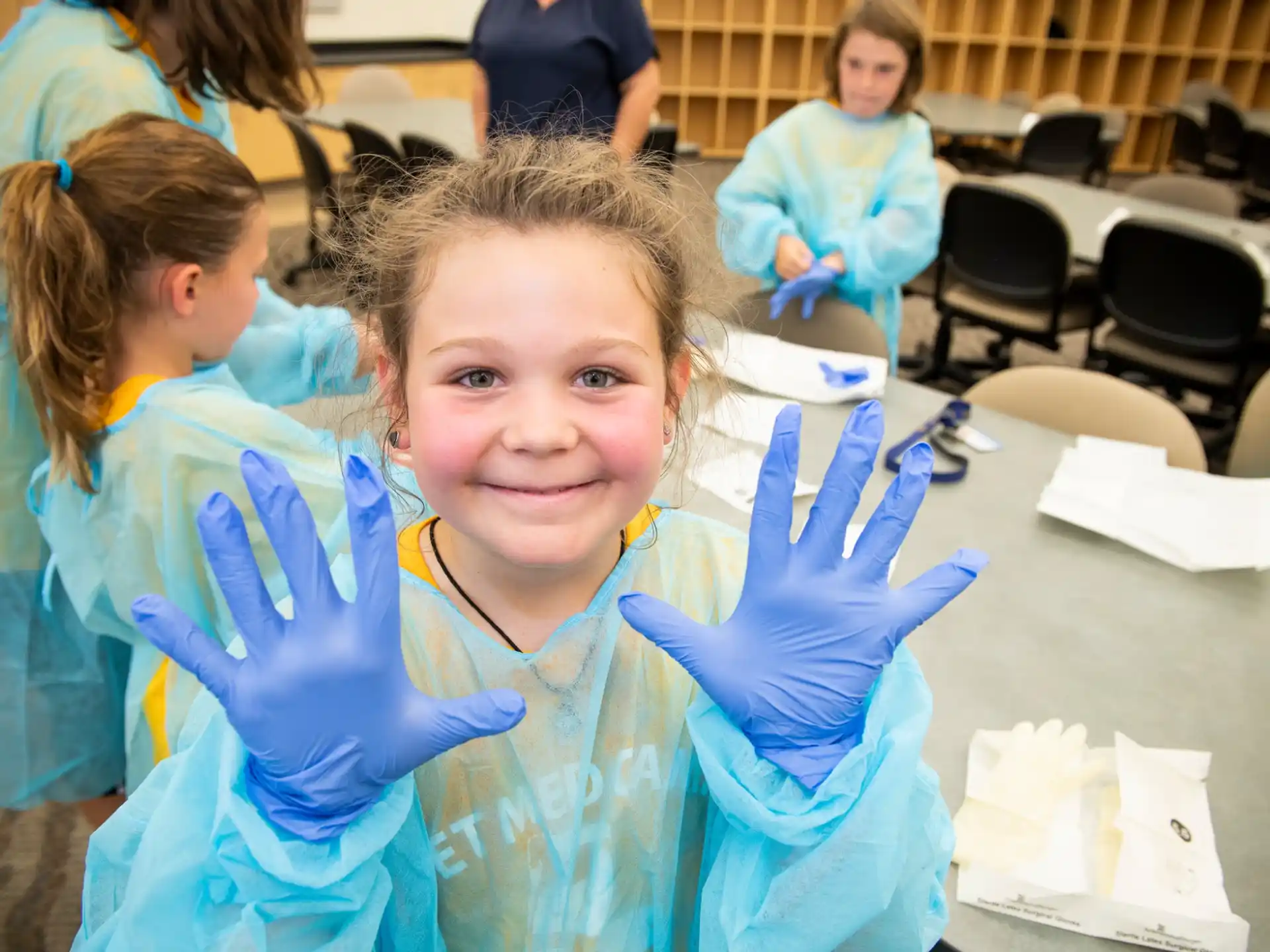 a girl with blue gloves