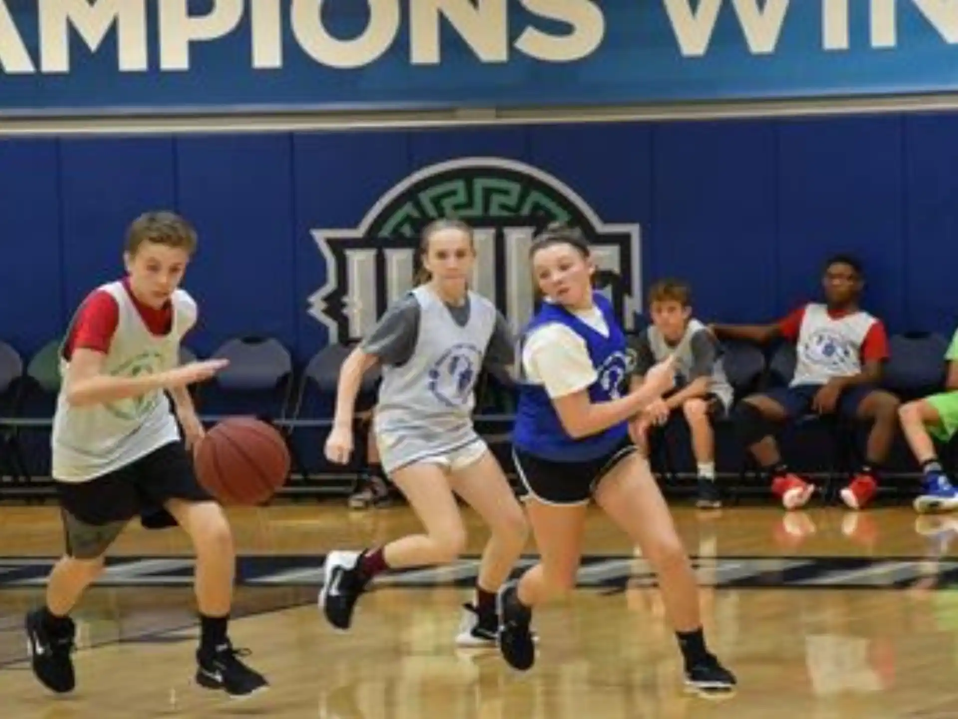 a group of people playing basketball