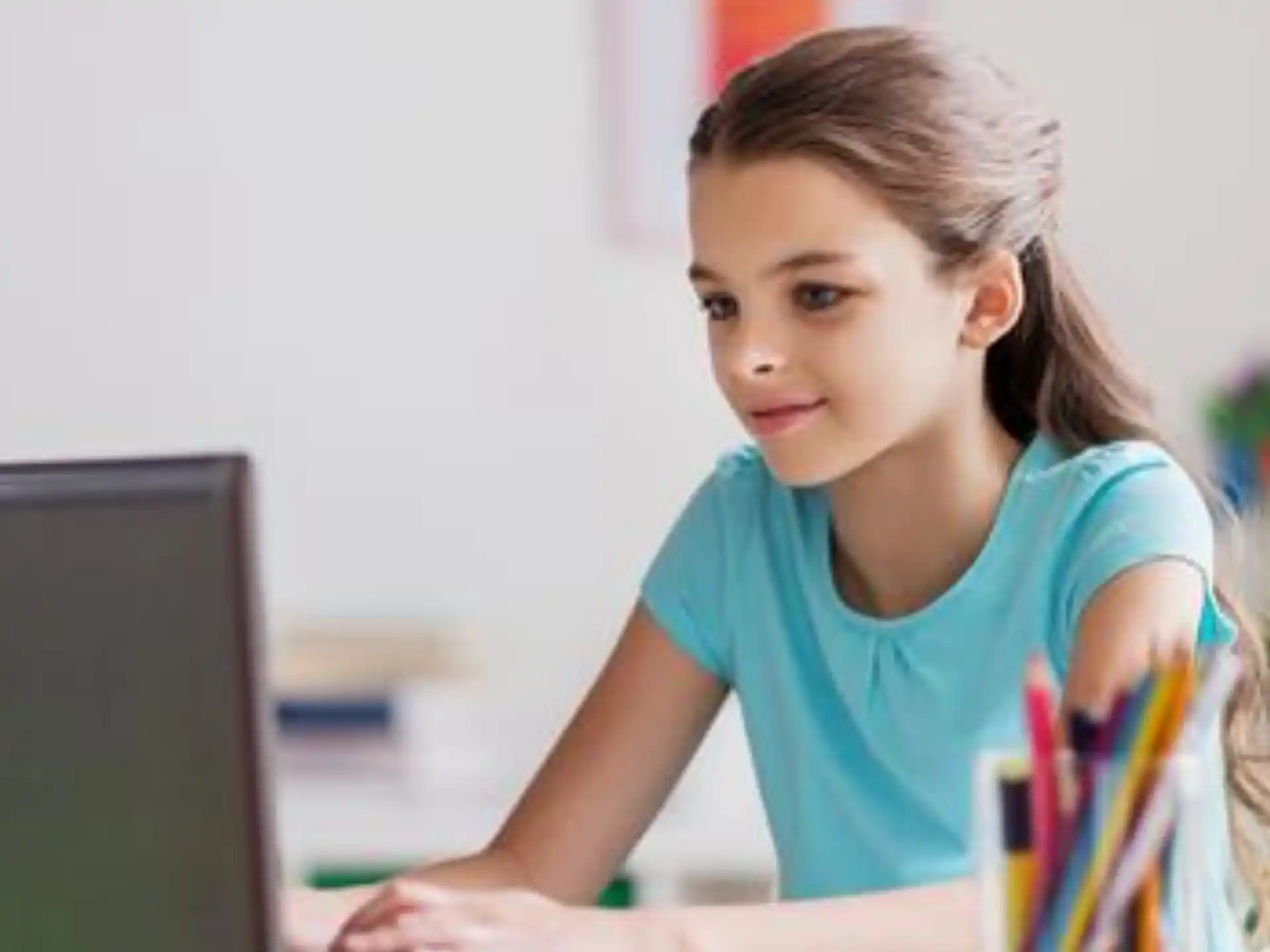 a young girl working on her computer