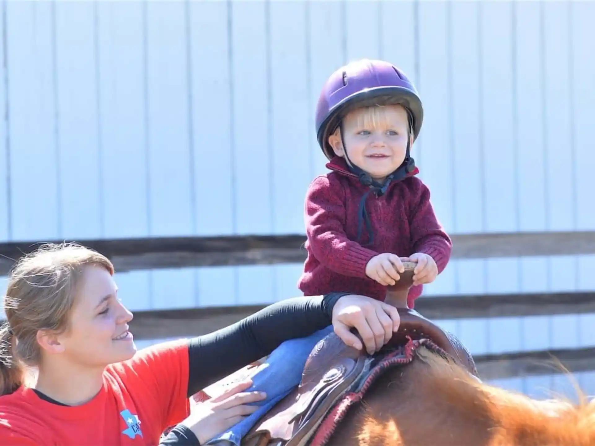 a person riding a horse with a child on the back