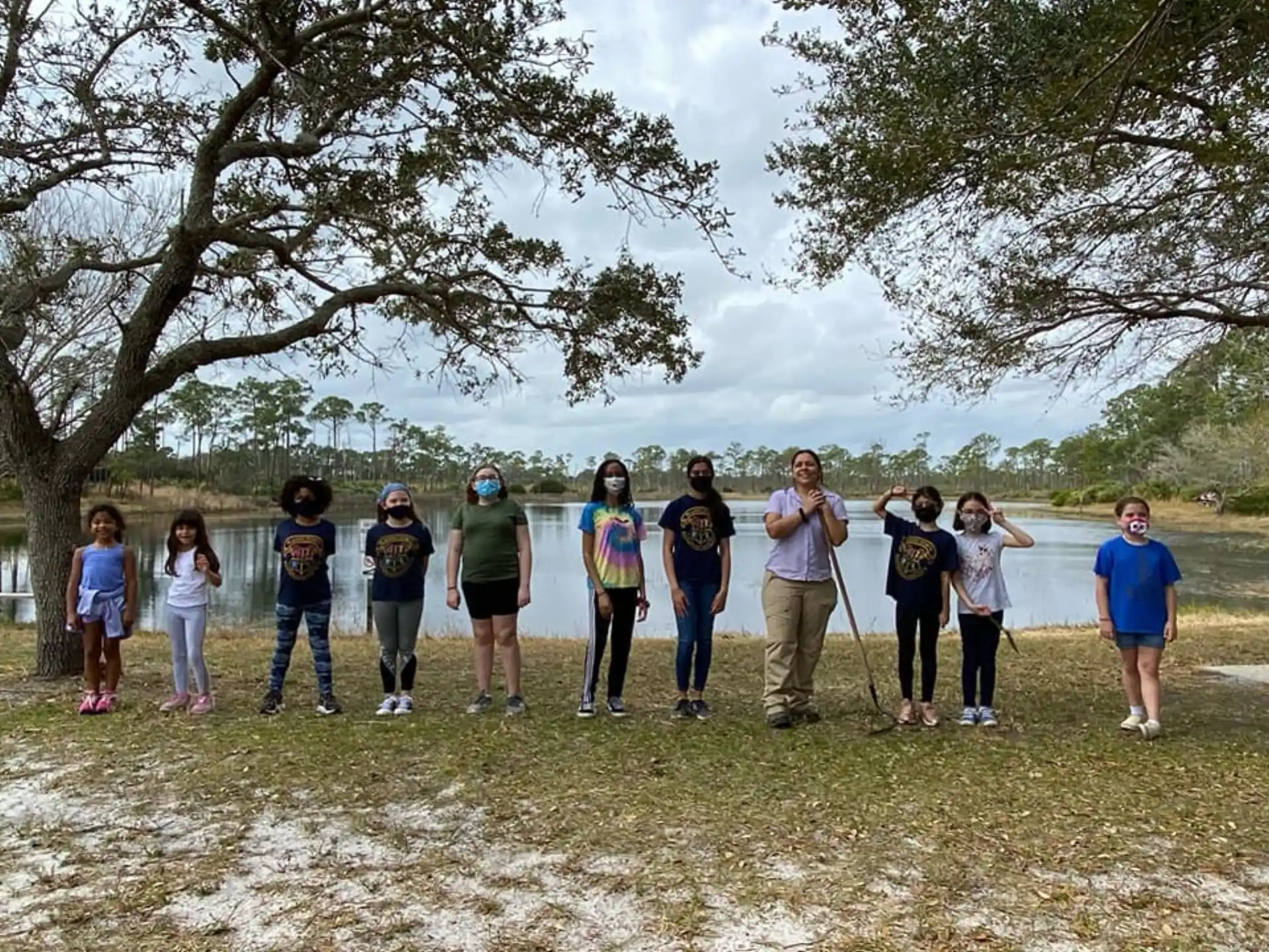 a group of people standing on a dirt path