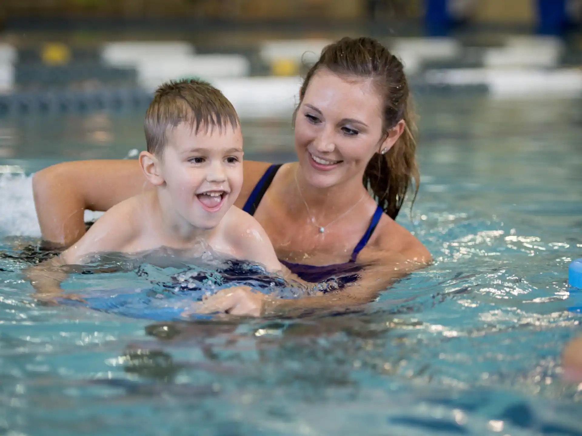 a woman and a child in a pool