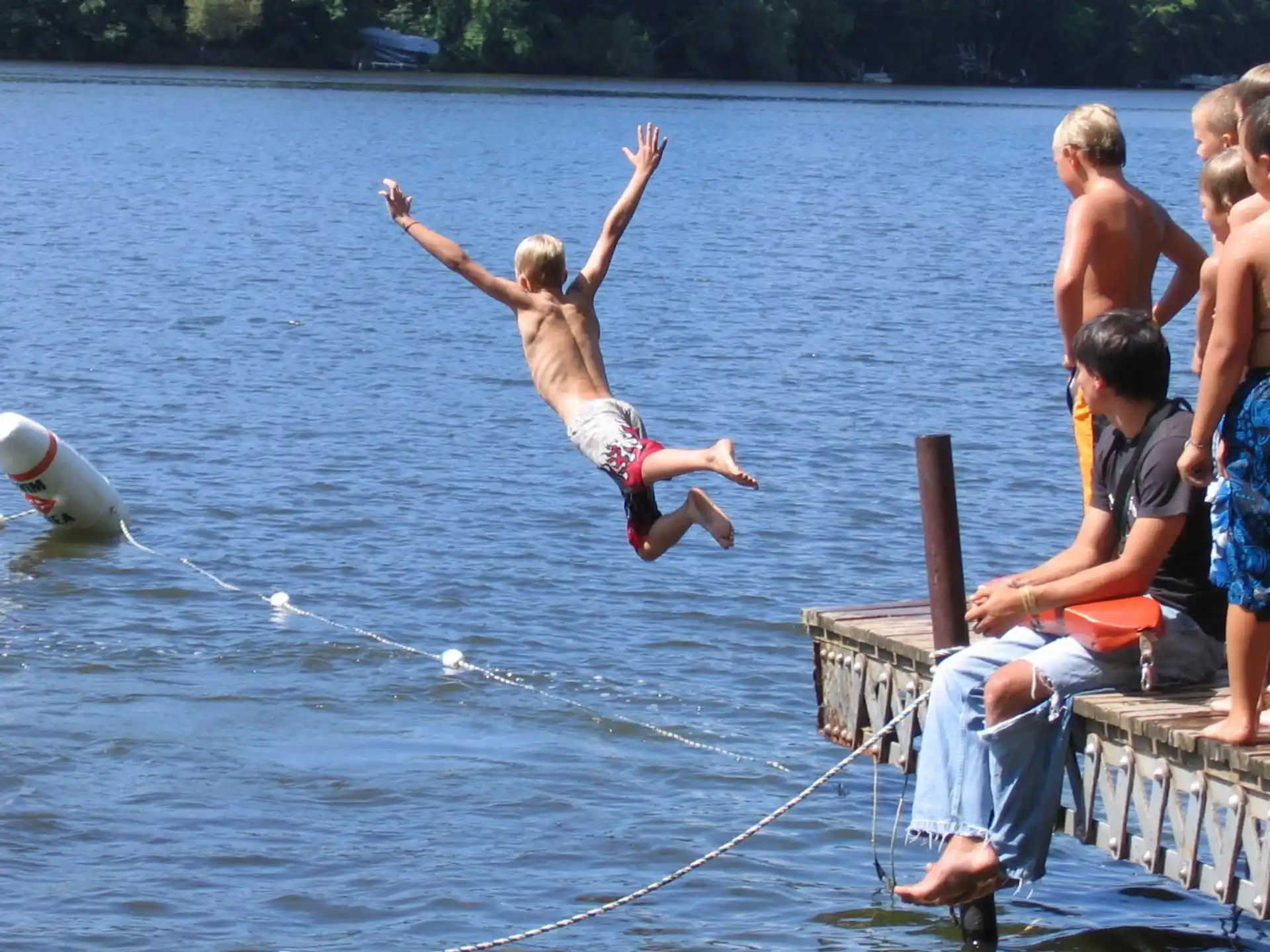 a group of people jumping into water