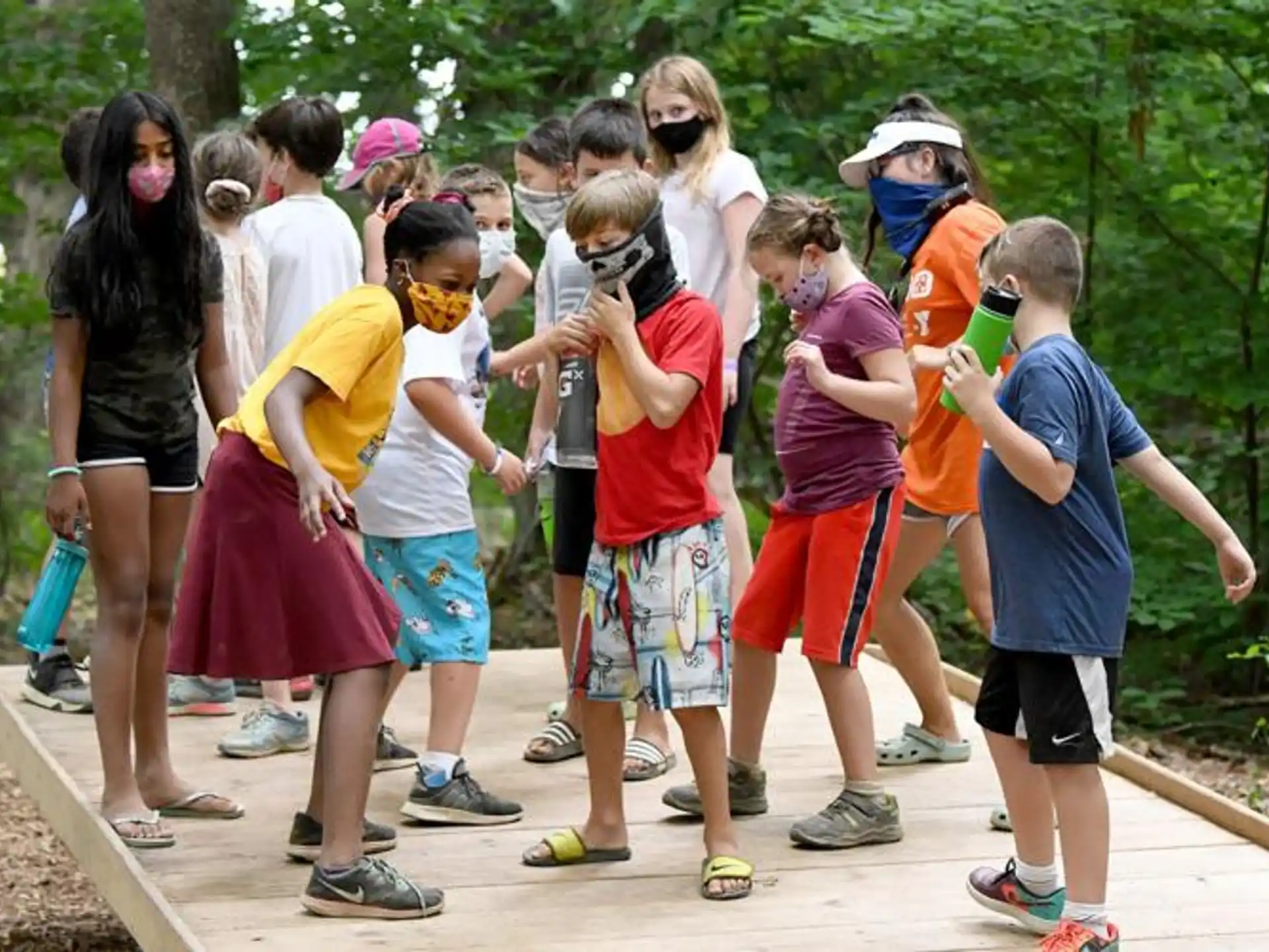 a group of people standing on a wooden deck