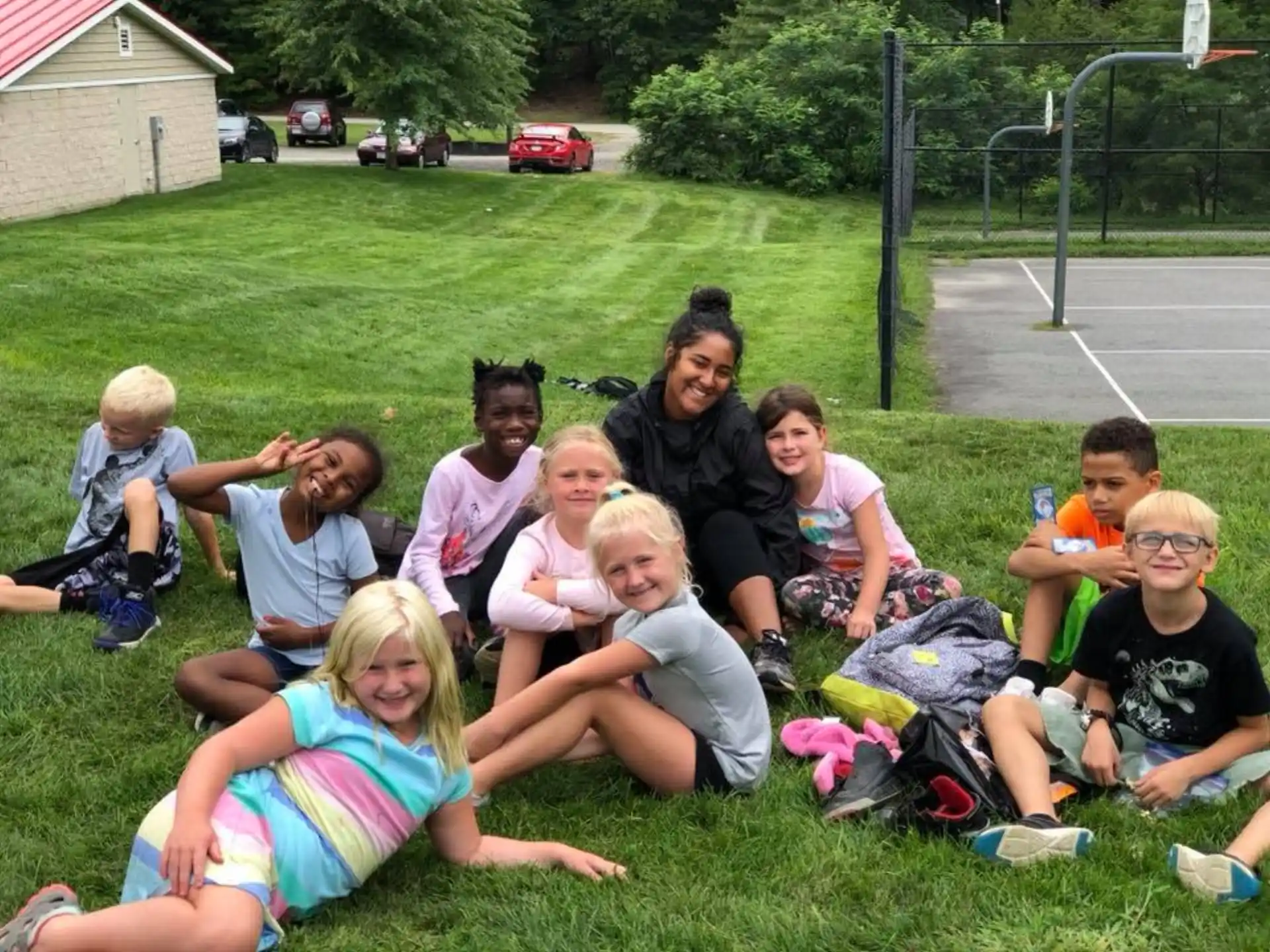 a group of people sitting on the grass