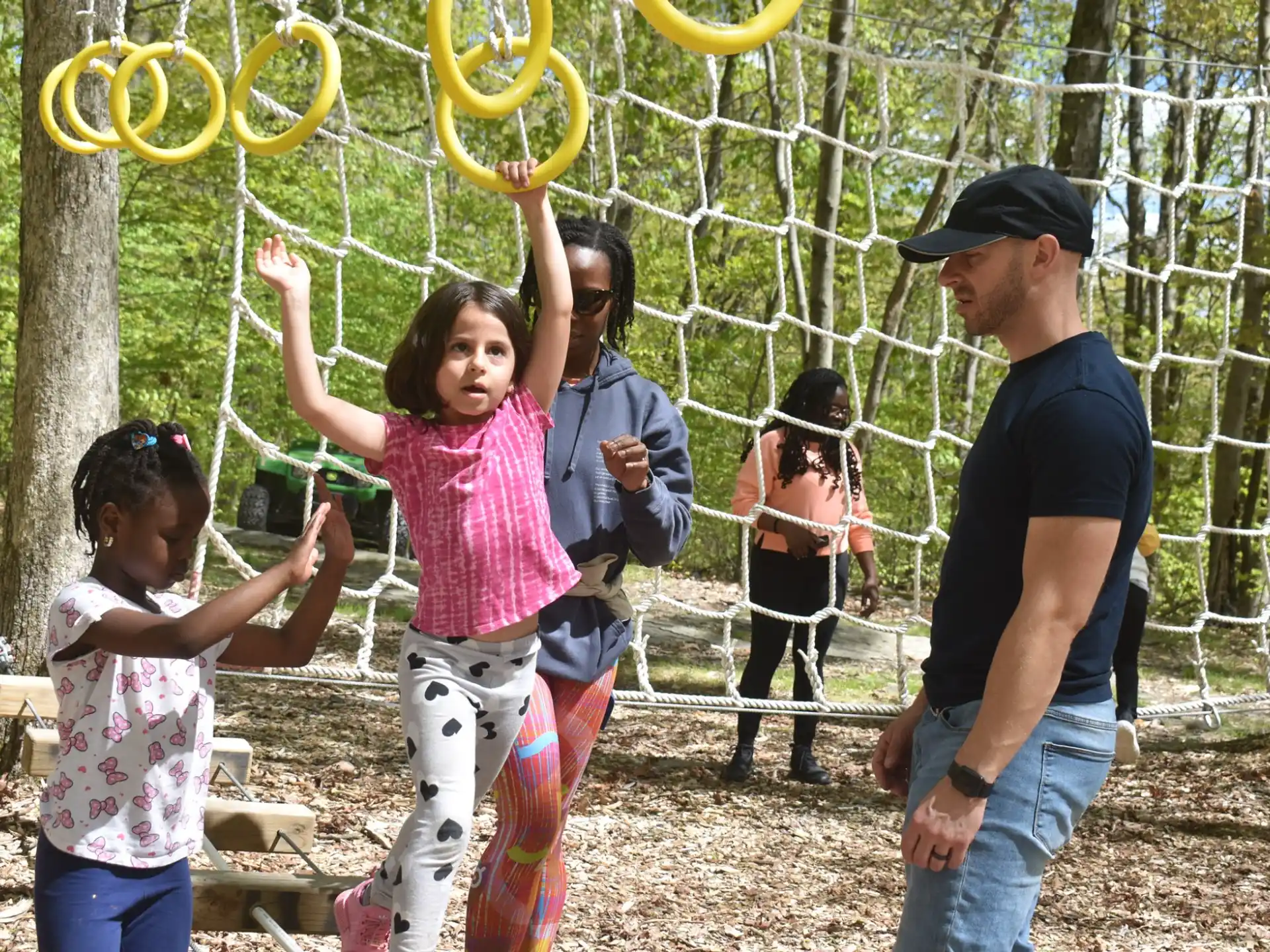 a group of people playing with a yellow hoop