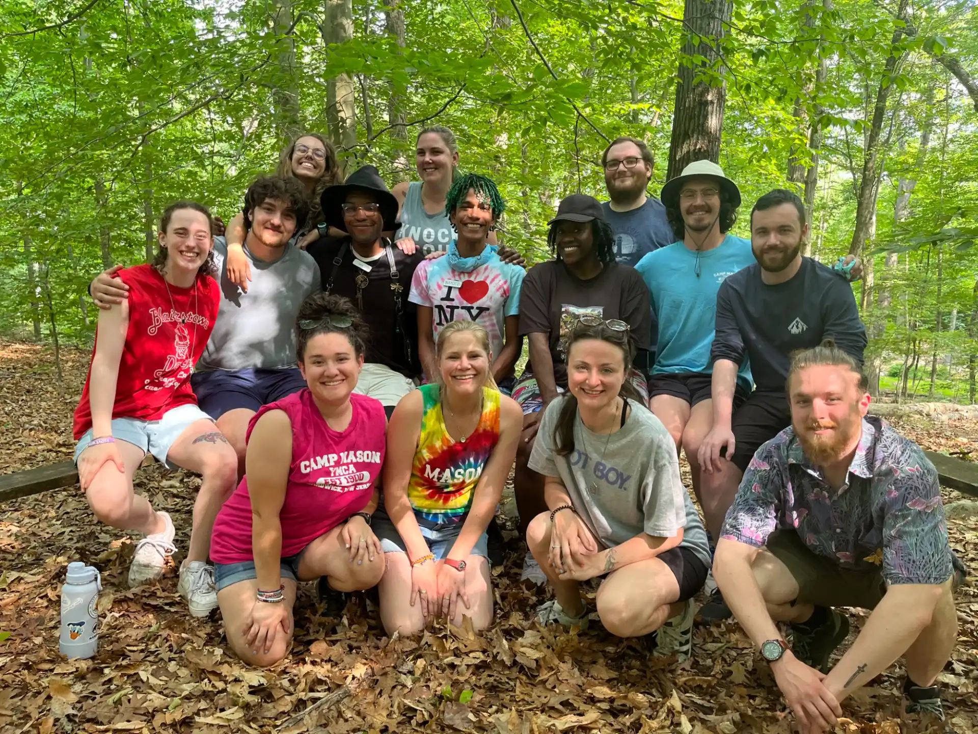 a group of people posing for a photo in the woods