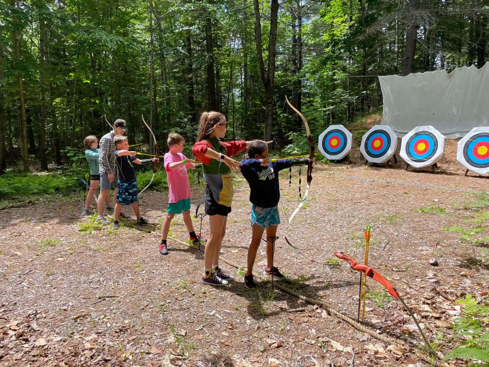 a group of kids playing in the woods