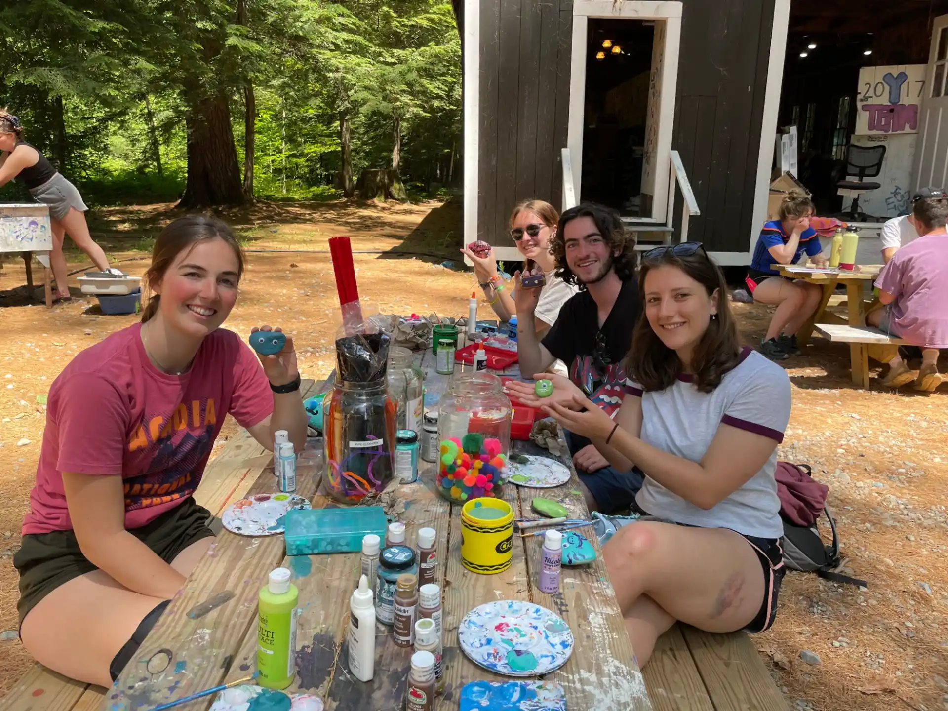 a group of people sitting at a table outside