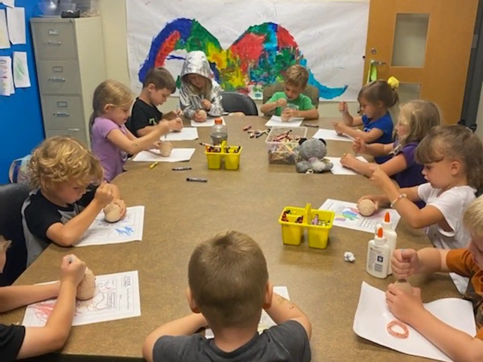 a group of children sitting at a table