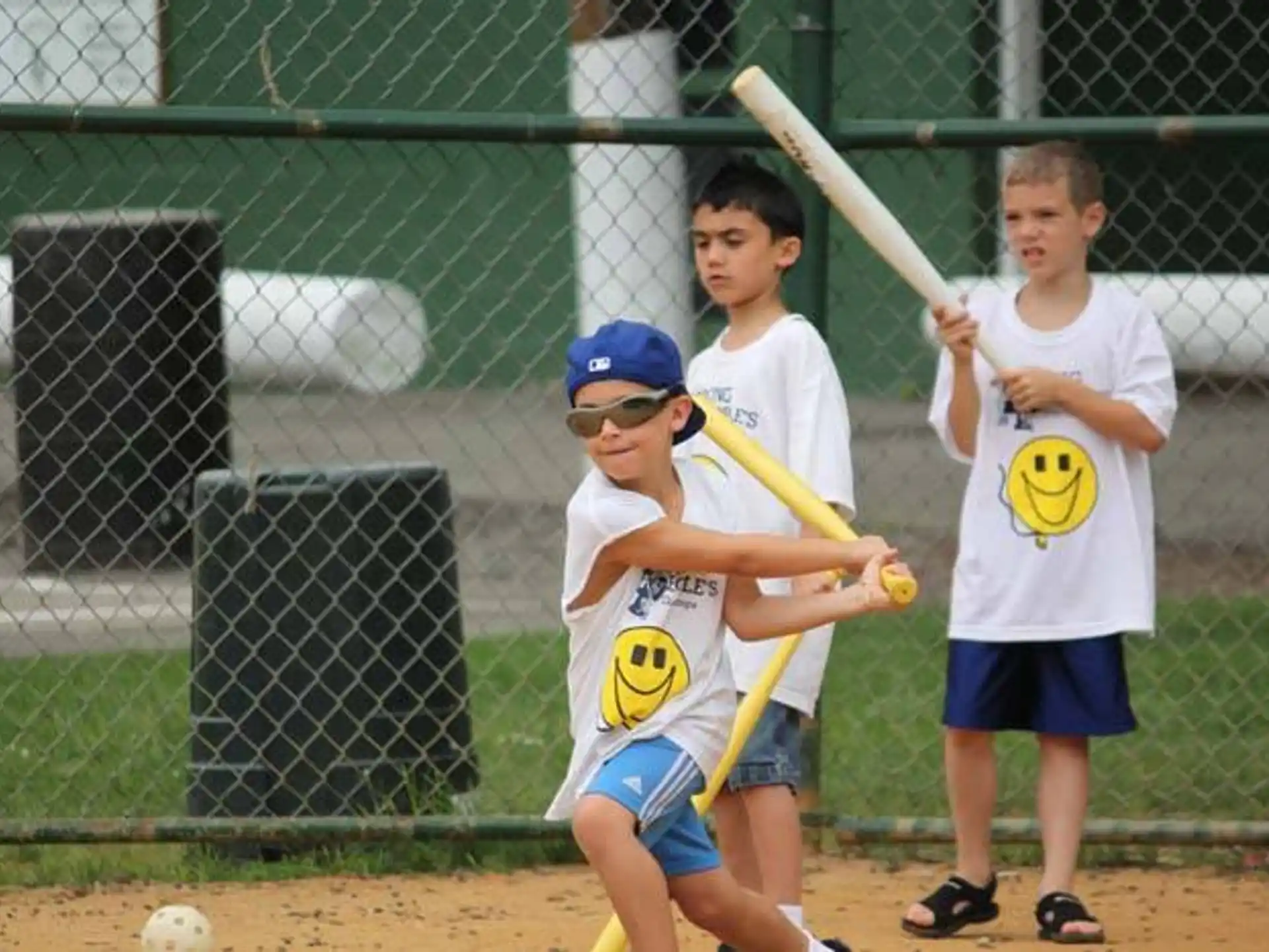 a group of kids playing baseball