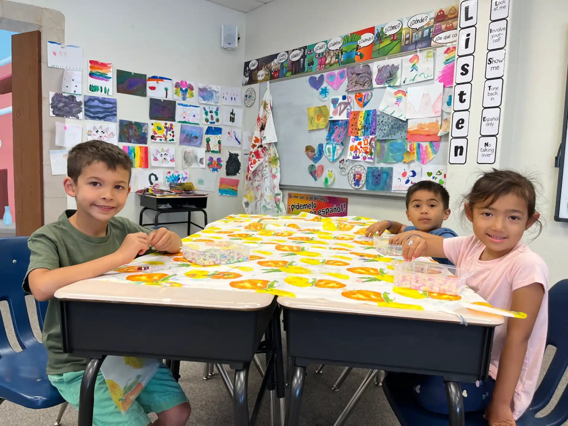 a group of kids sitting at a table with a board game