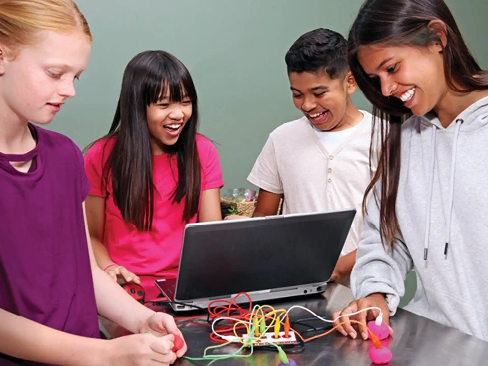 a group of people looking at a laptop
