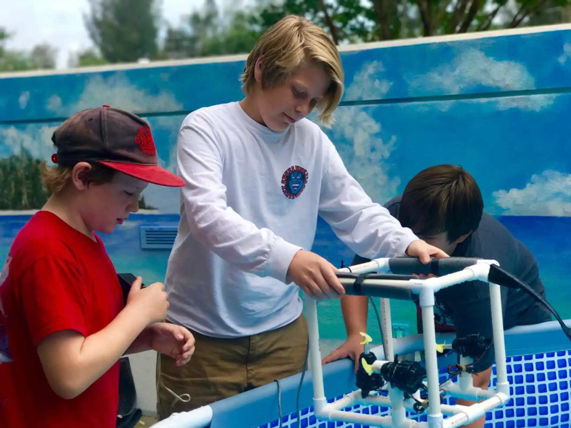 a few women working on a blue shopping cart