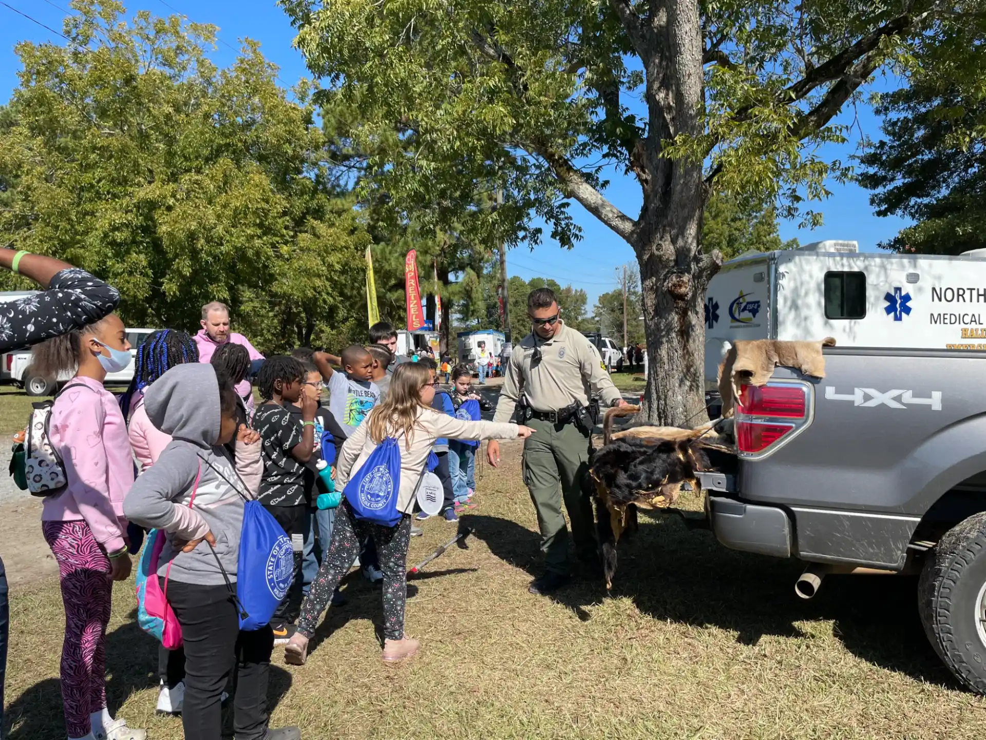 a group of people standing next to a truck