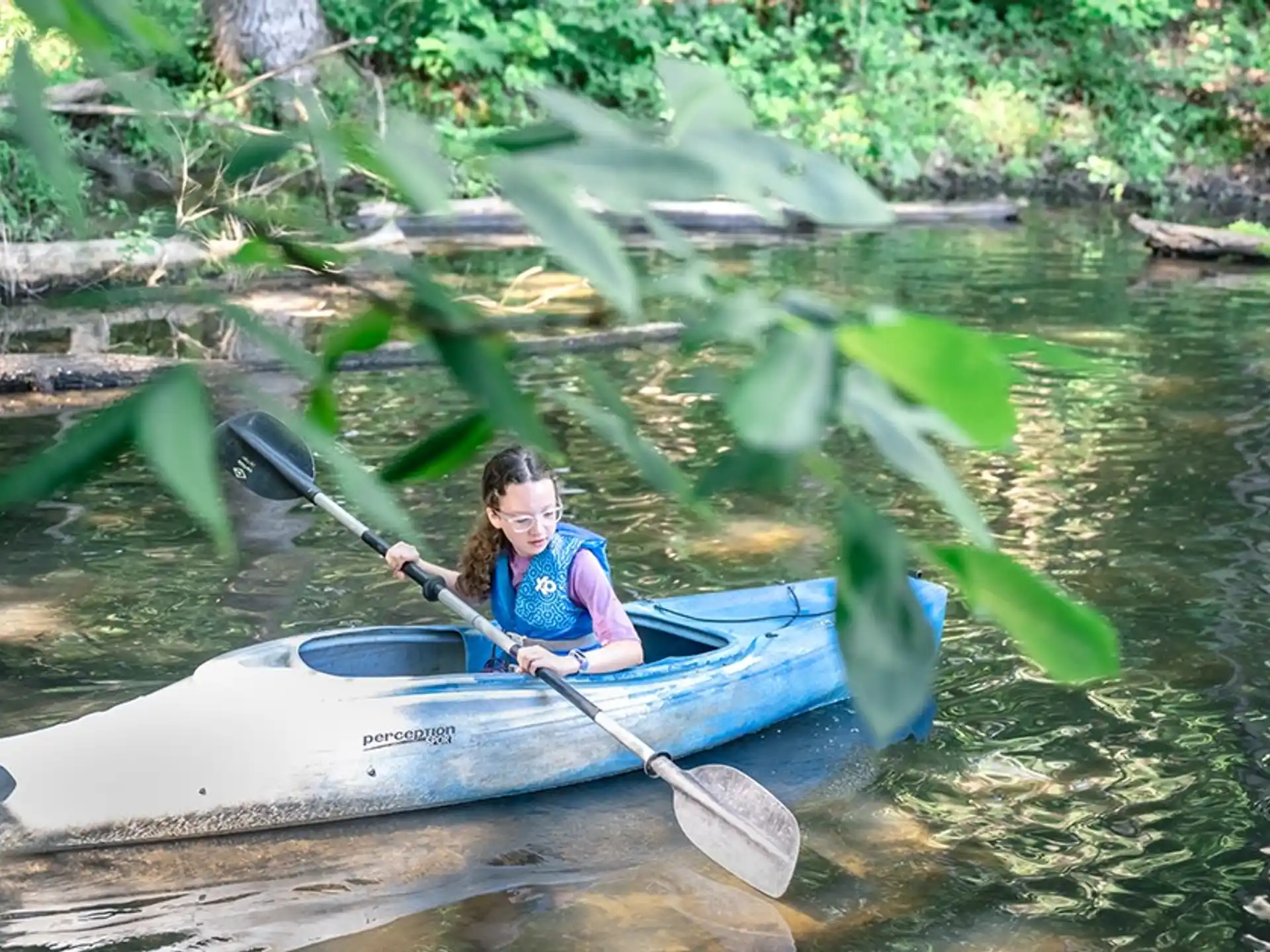 a person in a canoe on a river