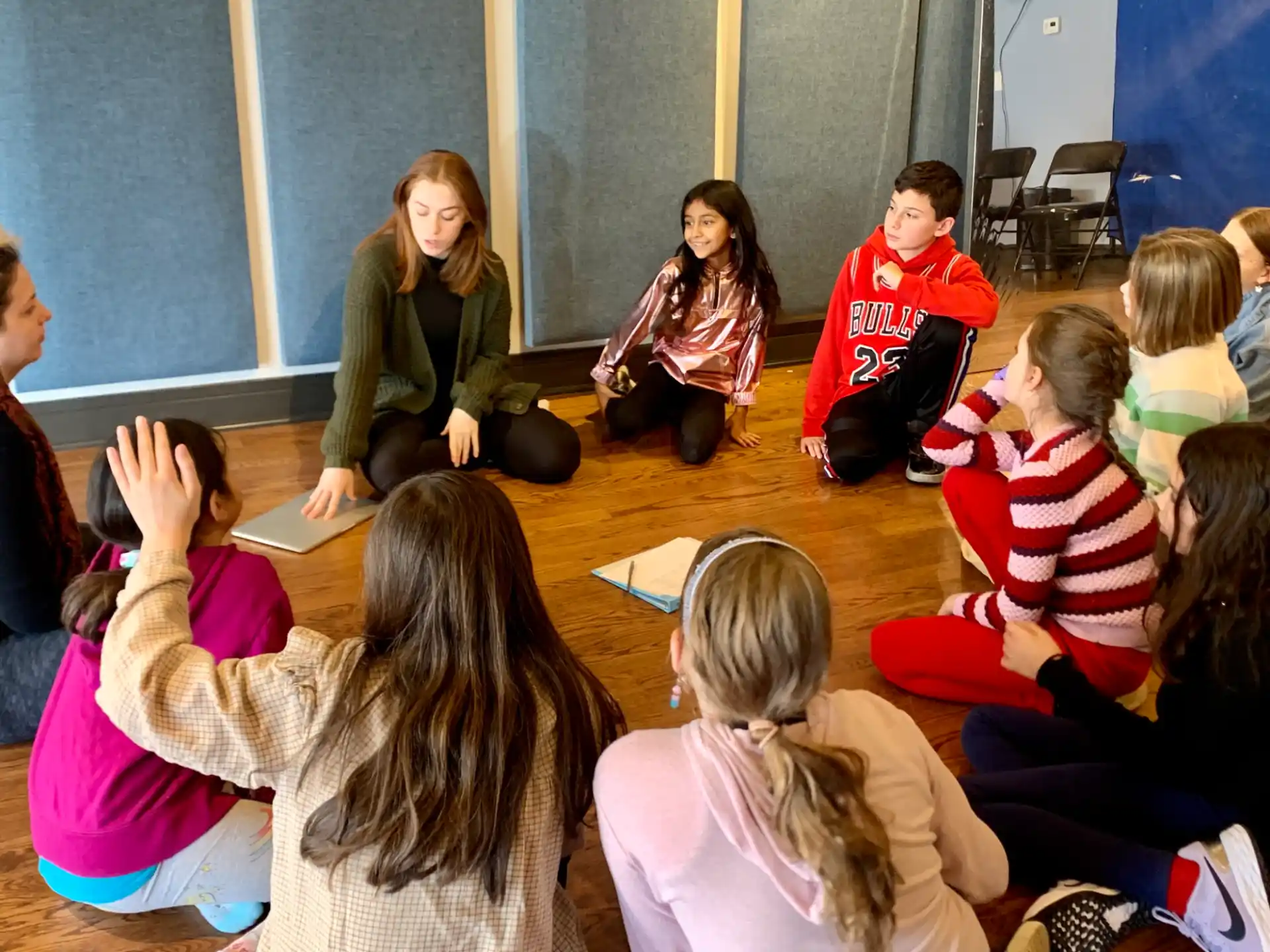 a group of children sitting in a circle
