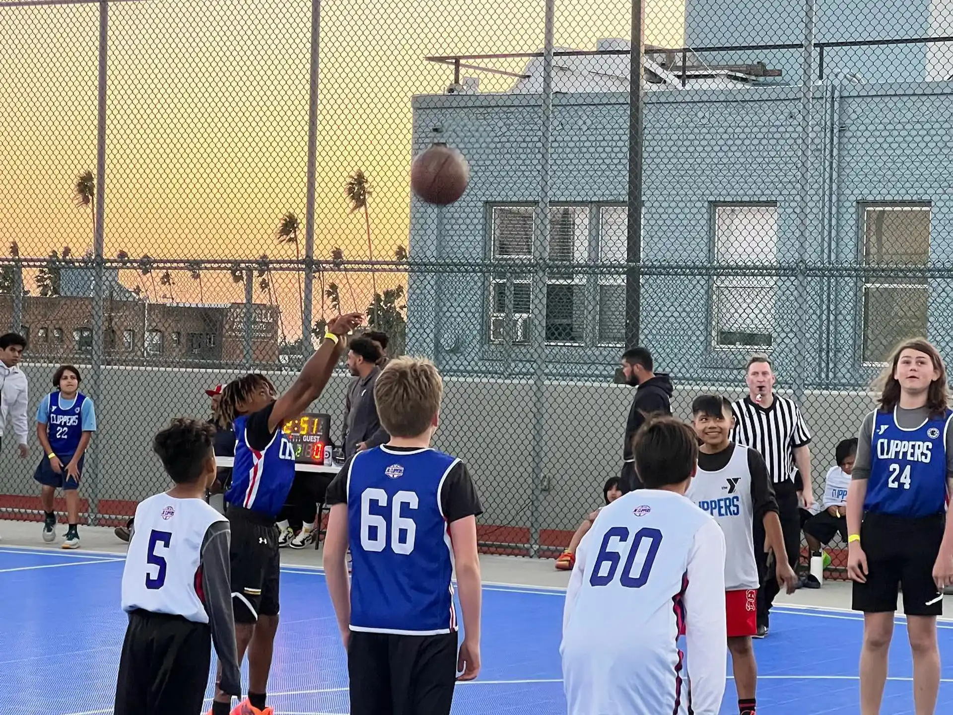 a group of kids playing basketball