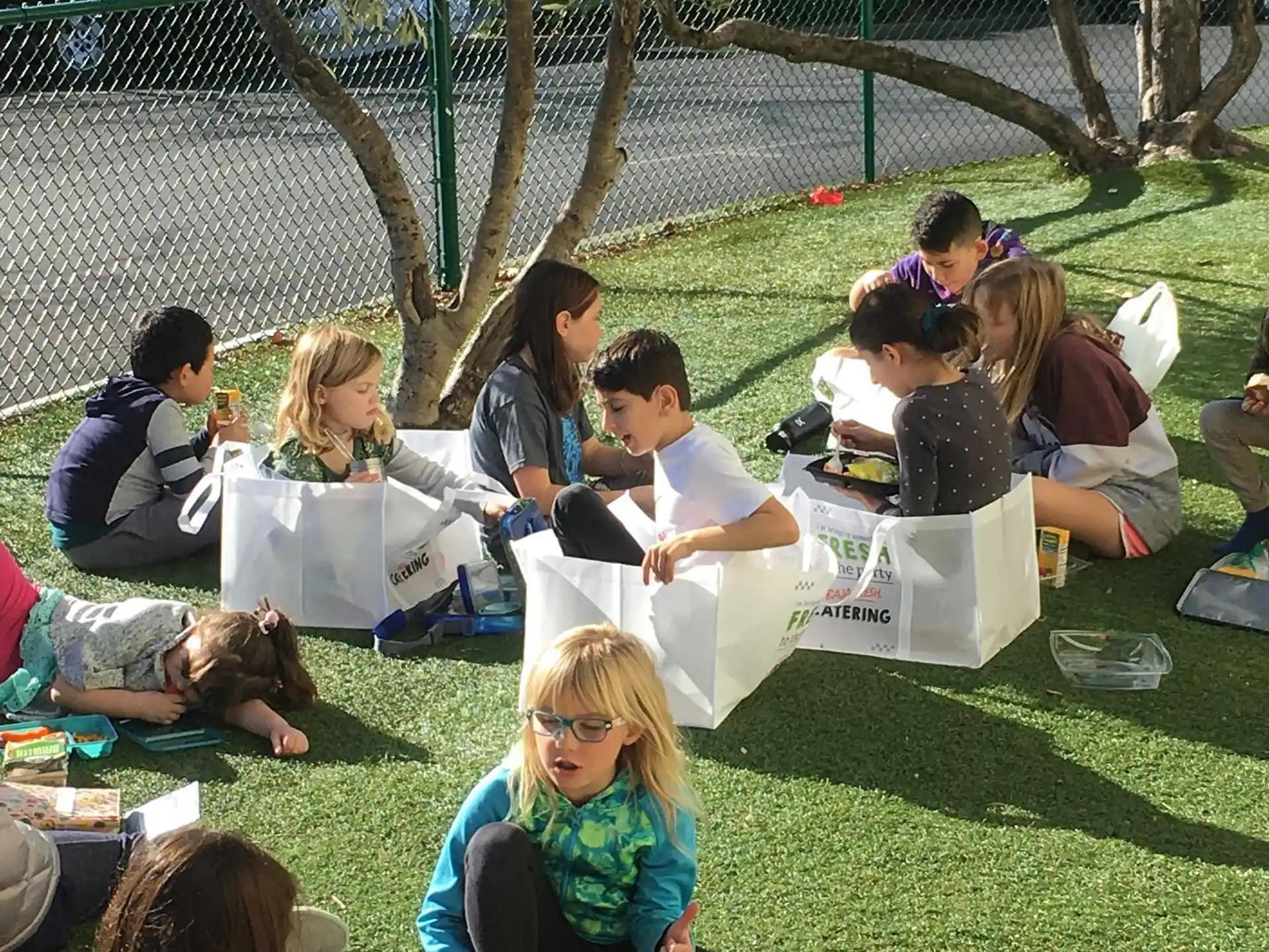 a group of people sitting on the grass