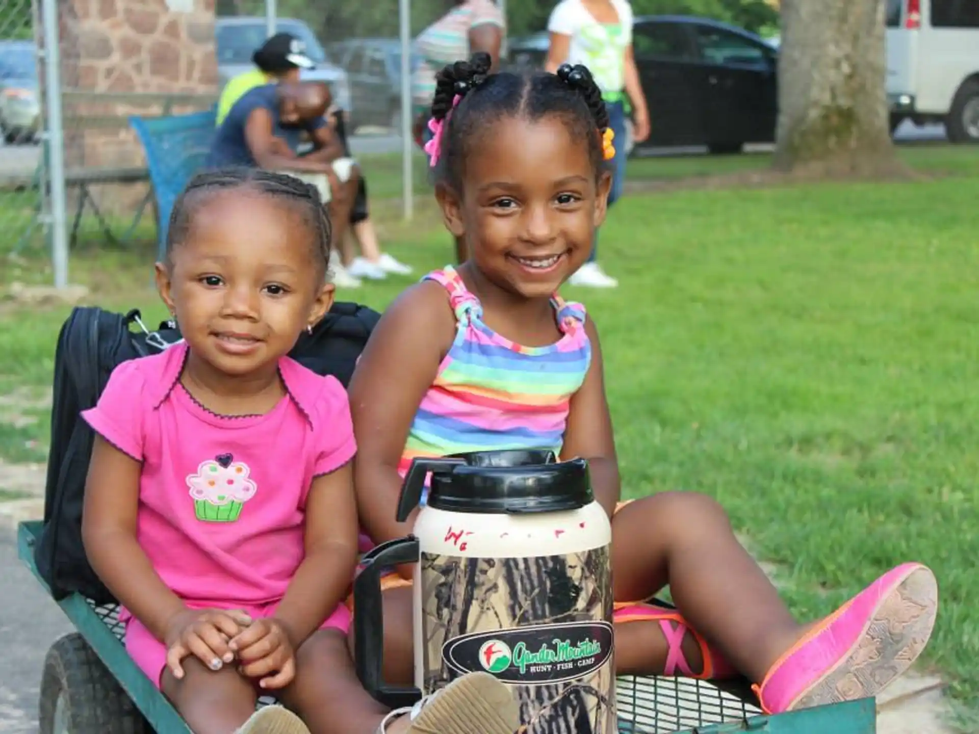 a couple of girls sitting on a bench