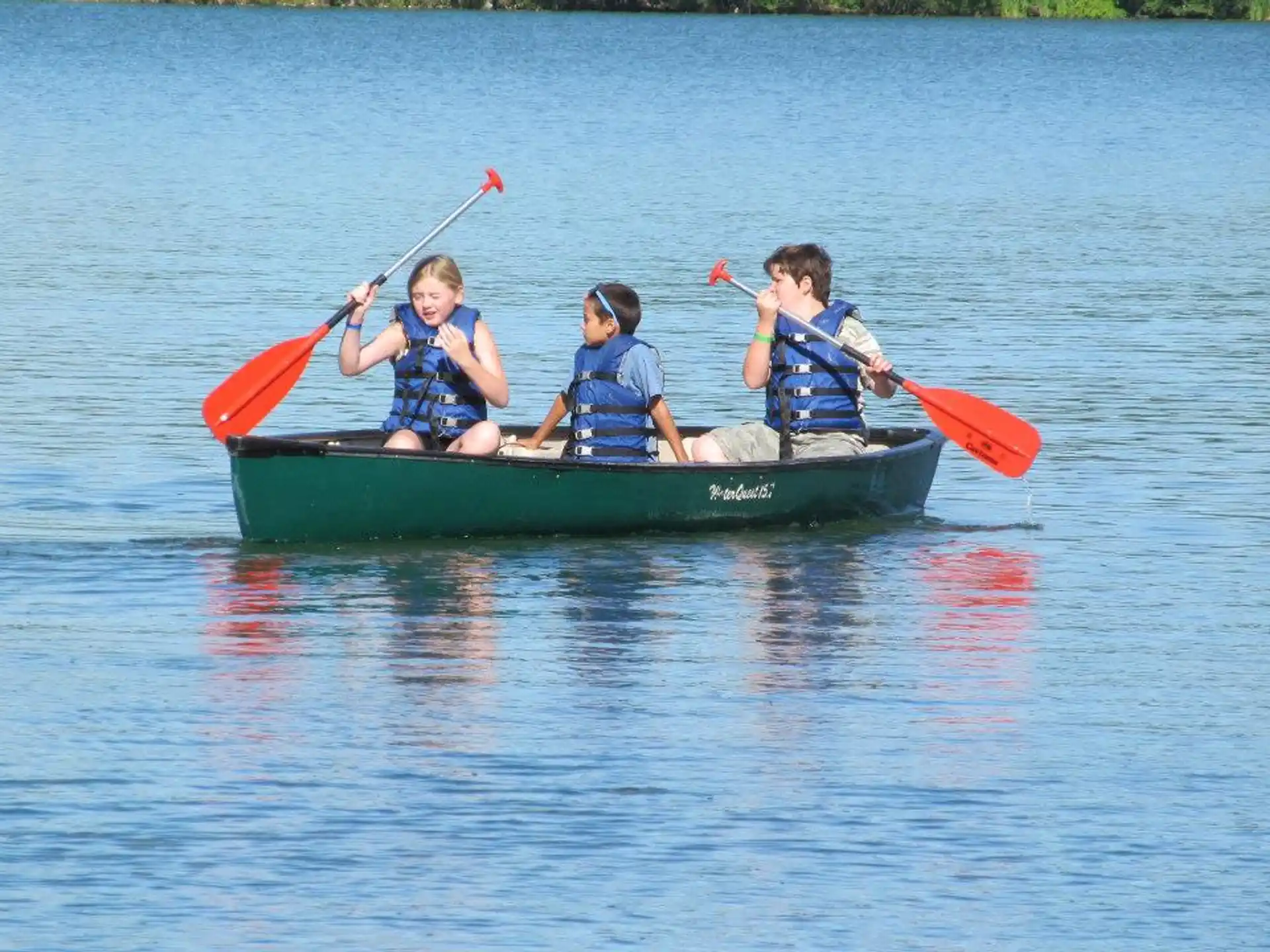 a group of kids in a canoe
