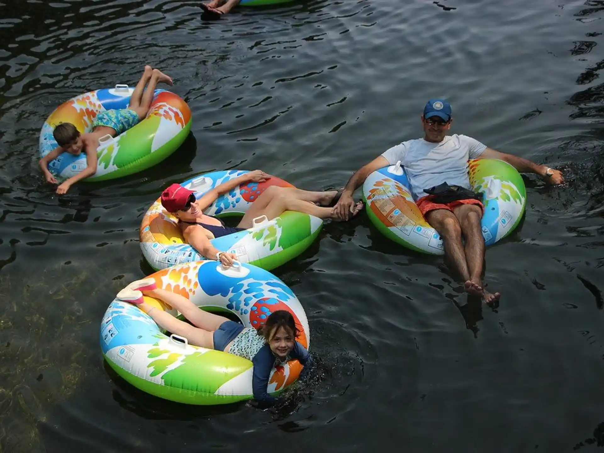 a group of people on inner tubes in the water