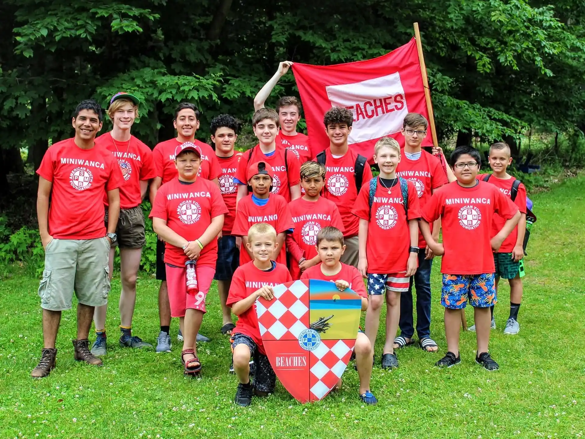 a group of people posing for a photo with a flag
