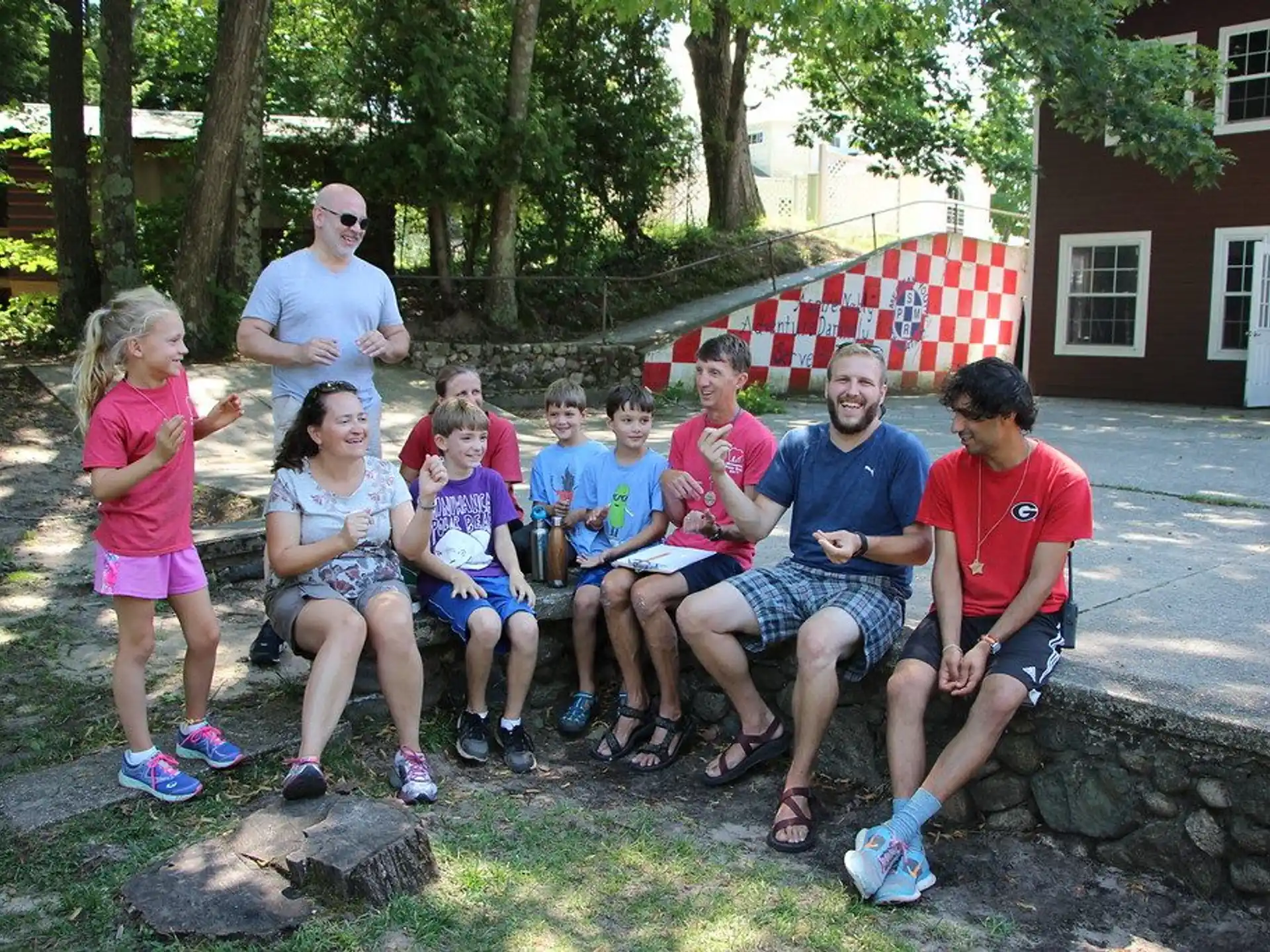 a group of people sitting on a bench in front of a building