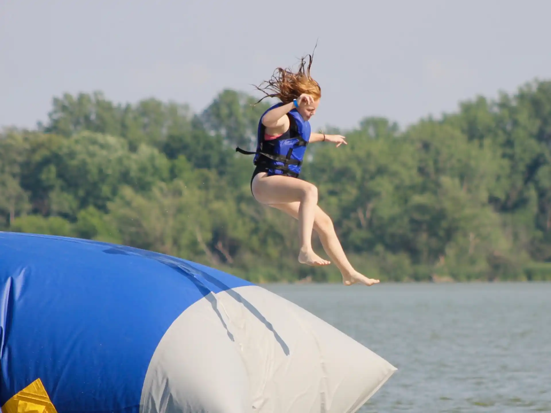 a girl jumping on a trampoline