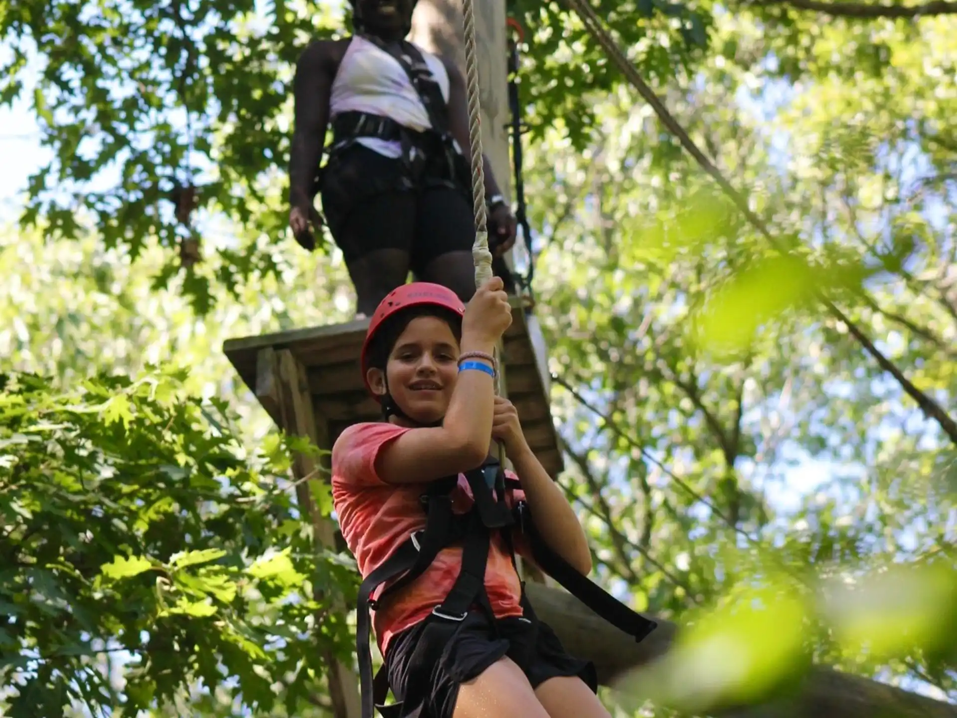 a woman and a man climbing a tree