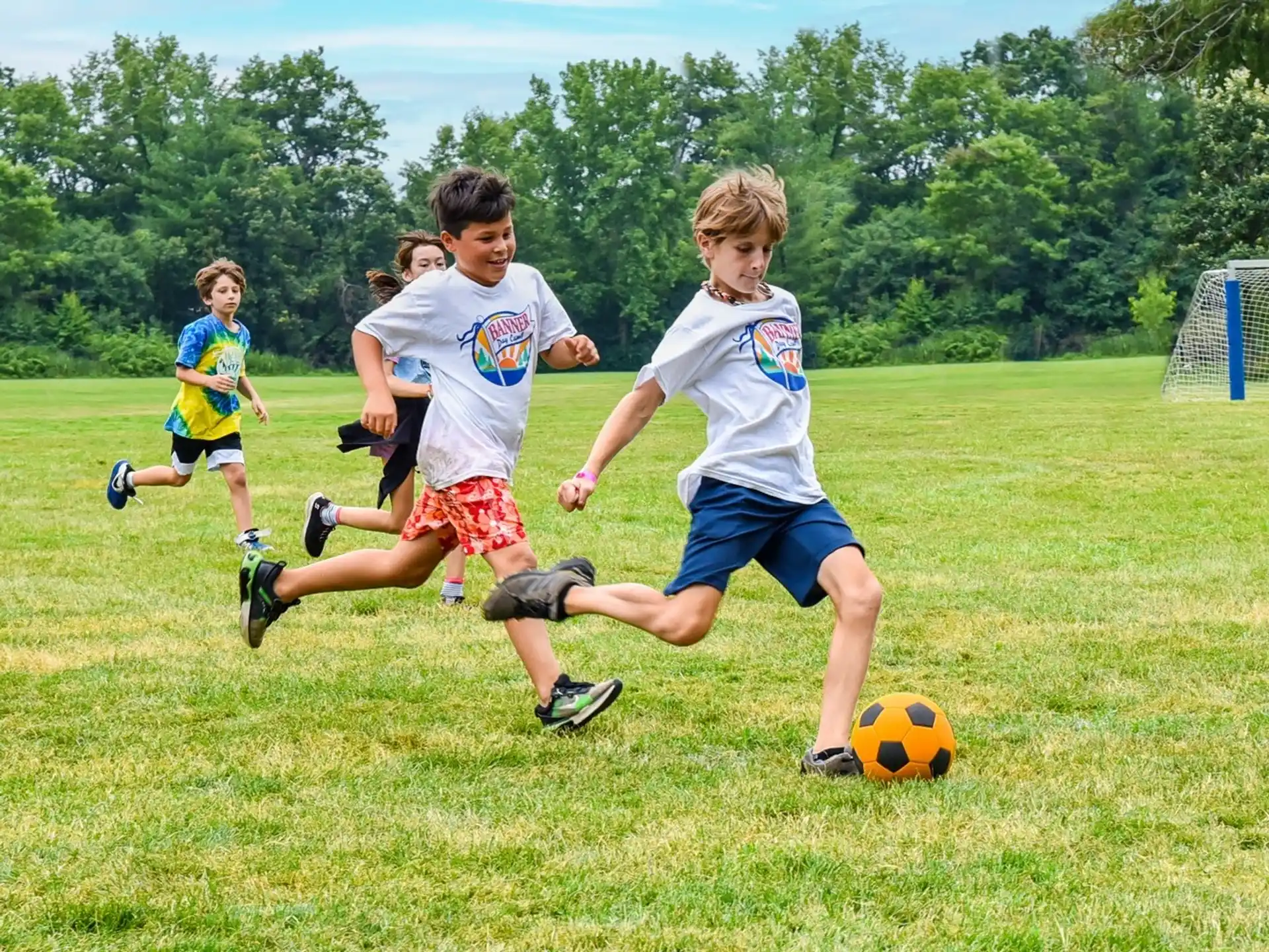kids chasing a football ball