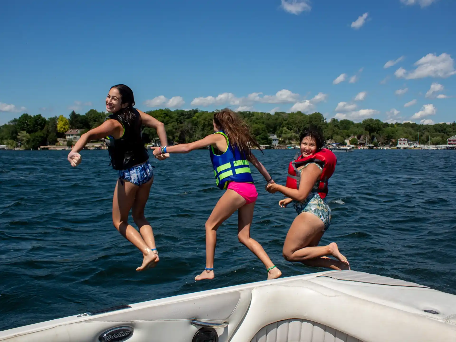 a group of people jumping into the water