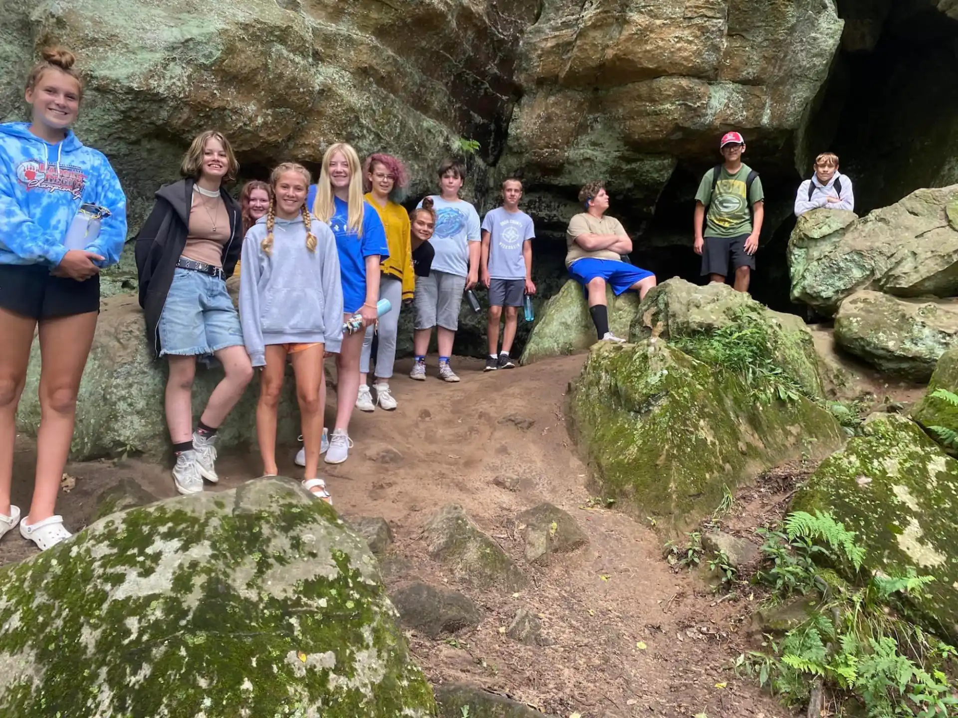 a group of people standing on rocks